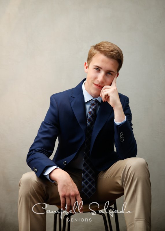  Senior photos, Portland Oregon&nbsp;of young man&nbsp;in front of a modern grey background by photographers at Campbell Salgado Studio. 