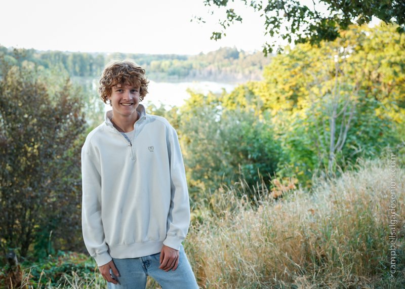  Senior photos, Portland Oregon&nbsp;of young man&nbsp;in front of an outdoor background by photographers at Campbell Salgado Studio. 
