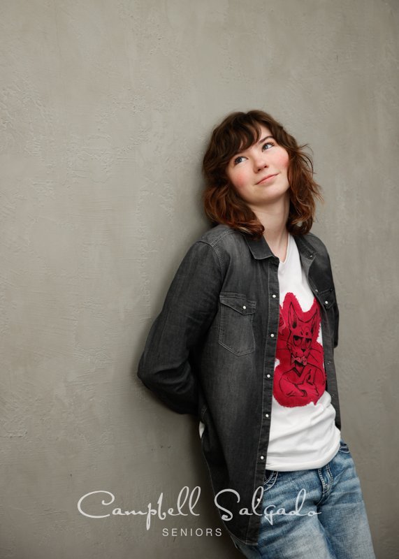  Senior picture of a young woman on a modern grey background by high school senior portraits photographers at Campbell Salgado Studio in Portland, Oregon. 