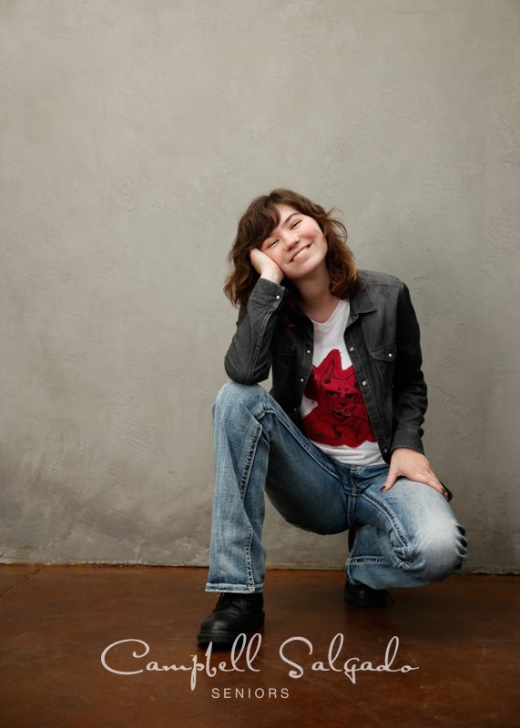  Senior picture of a young woman on a modern grey background by high school senior photographers at Campbell Salgado Studio in Portland, Oregon. 