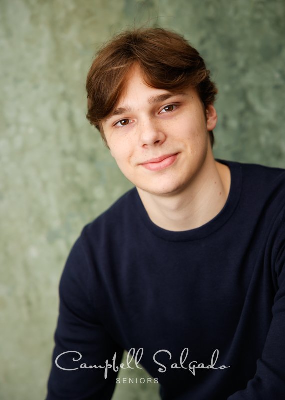  Senior picture of a young man on a rain dance background by high school senior portraits photographers at Campbell Salgado Studio in Portland, Oregon. 