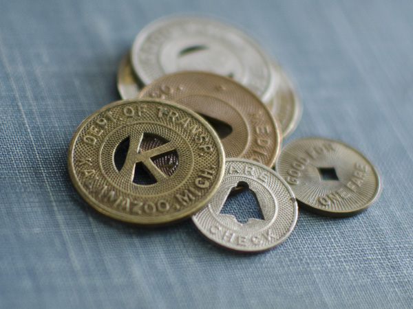 One type of piece that I'm always searching for inspiration for is an every day piece. Something close to the neck, simple, something that becomes a part of you. It just feels good to me to have a piece that I rarely take off. It becomes part of your identity for the time being. I began with my go to, old coins. I love coins because they have this great graphic sensibility. They have been through so many hands, have a patina that can't be recreated, and they have instant history. (I did find several ancient coins that fit the bill that I will be featuring in the months to come.) My search for coins led me to subway tokens/bus/rail tokens. Lets just call them transit tokens. I have collected at least 40 varieties from all over the country. I've found them to be stunning. They reach back to the early 1900s in date. They are solid, some ornate, and all around just really cool. Several have a letter punched out in the middle. I started working on the idea of building an entire alphabet of them. That has been easier said than done. The letters that I have will make great gifts to someone owning that particular initial. Other tokens just are very interesting. They pair very well with natural stones too! I've created some necklaces and a few pair of earrings, but will have a lot more designs ready by my September 6, Kankakee Farmers Market. I can't wait to show you my new pieces! I will send pictures of them in my next email! Thank You for reading! Have a great day! Mandy