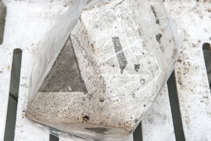 Untitled (Burnt Sienna) (detail) 2014 concrete, plastic bag, salt, solid watercolour, water and plastic chair 84 x 46 x 42 cm