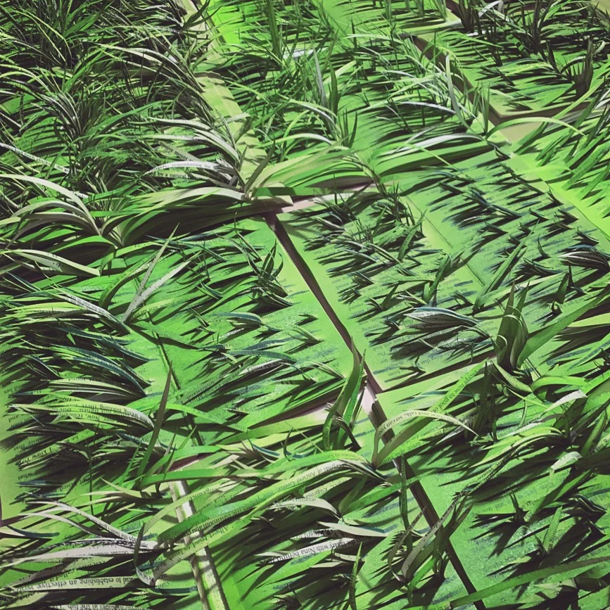 A display of recycled papercut green grass by Adrienne Dunkerley for inventions of summer display.