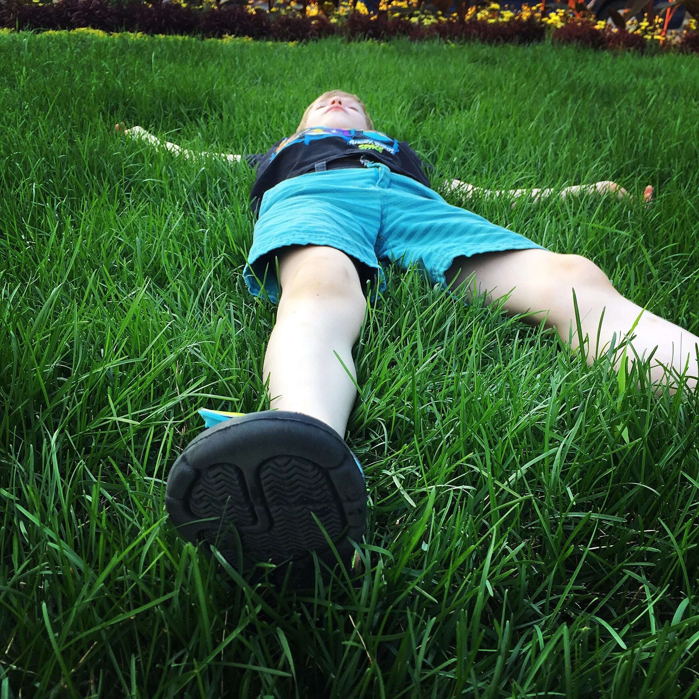 boy-relaxing-grass-savasana.jpg