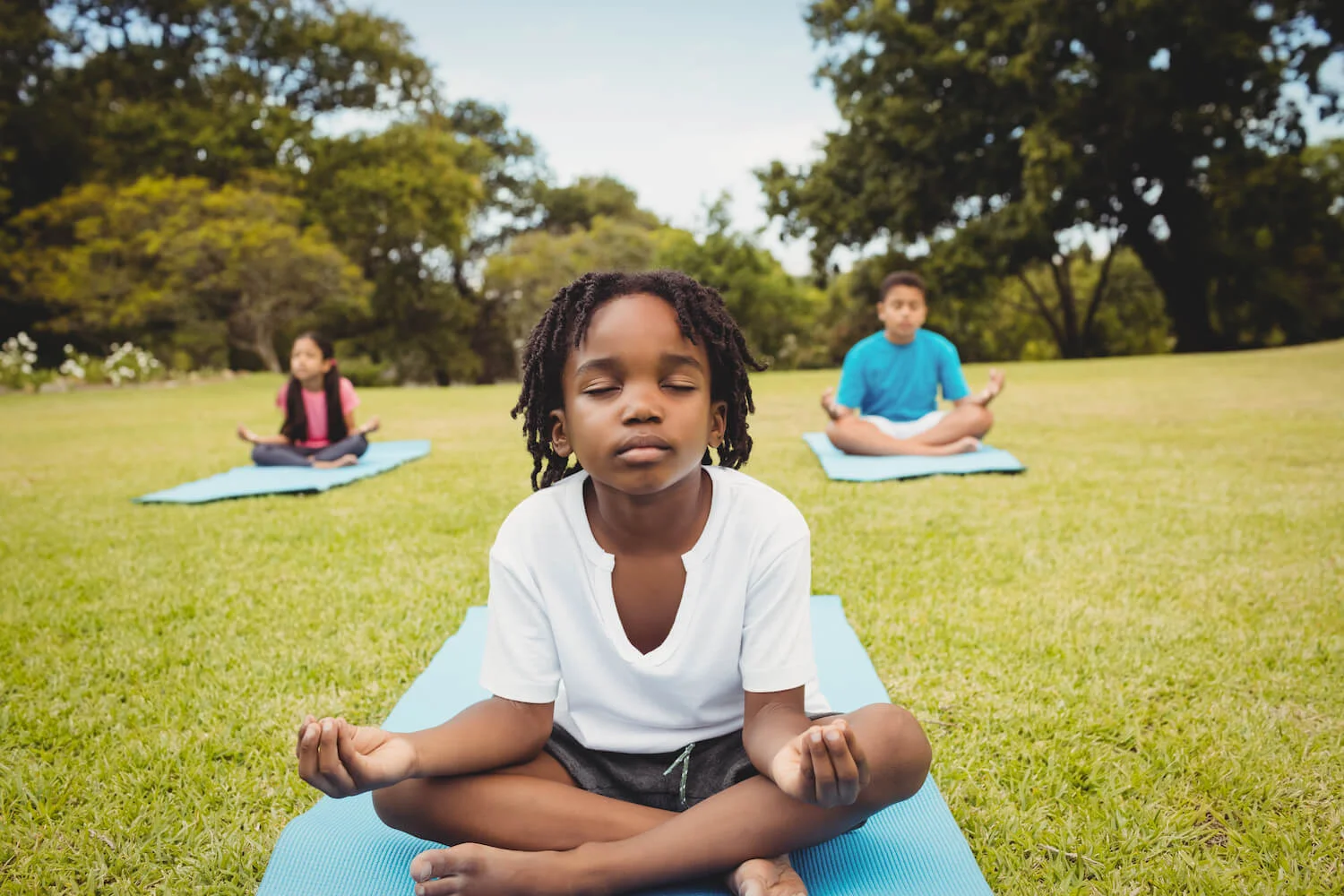 boy-meditation-yoga-park-smallweb.jpeg