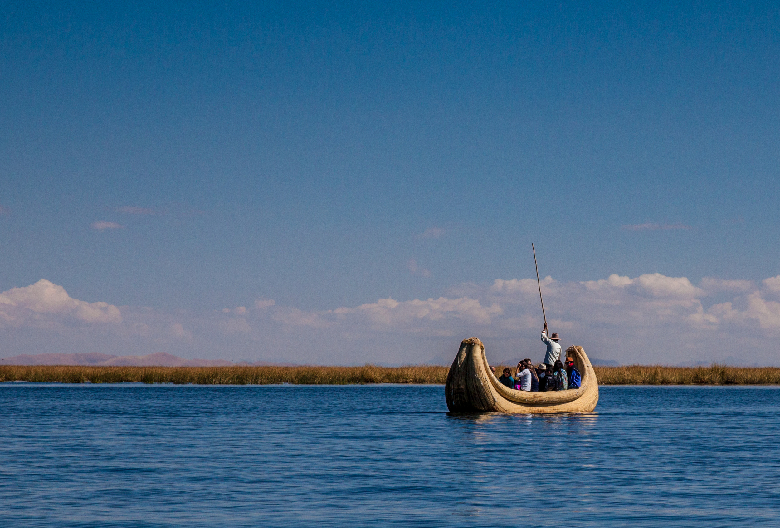 The totora reeds are in the background with the mountains on the shore even further off in the distance