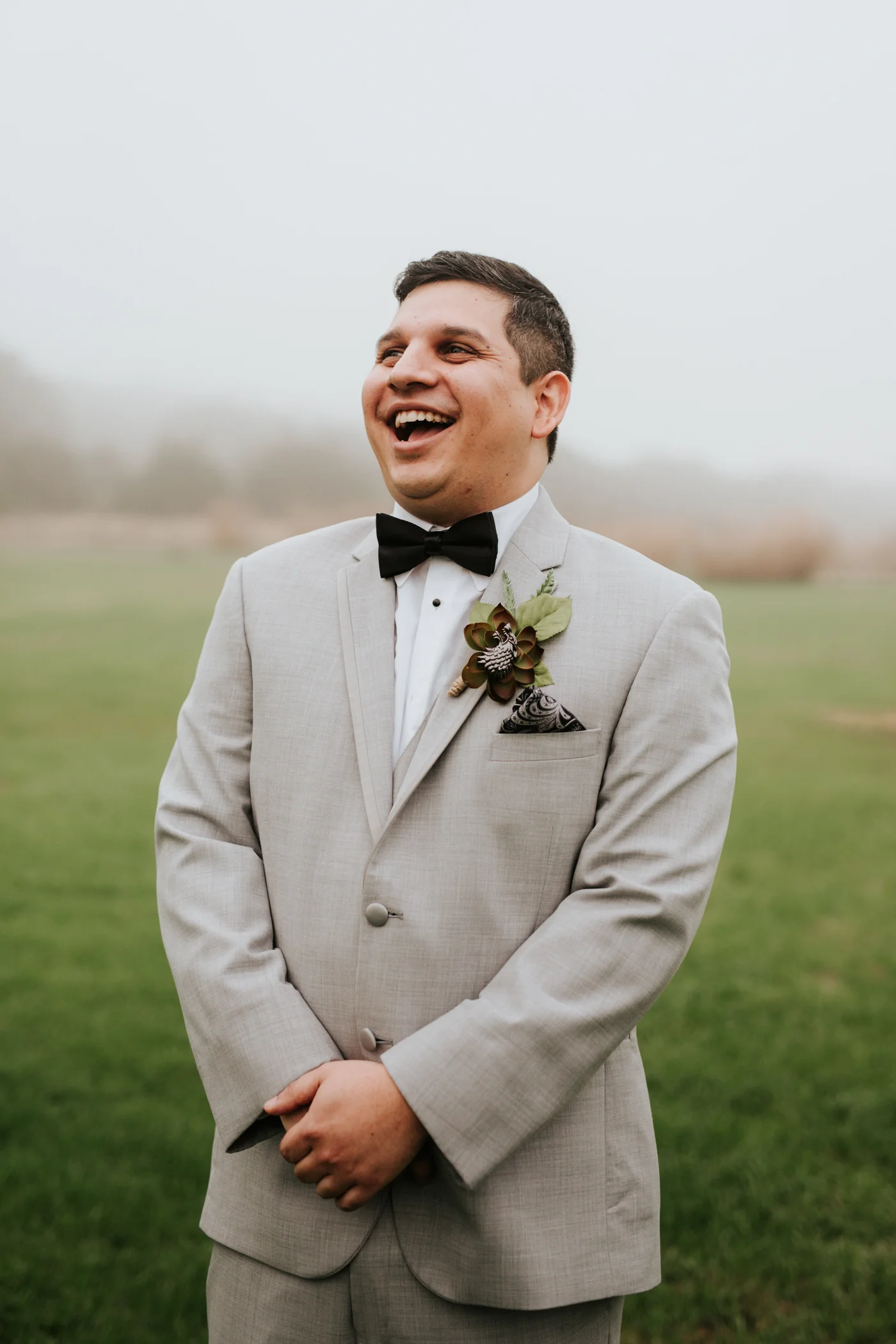 Groom laughing at Pecan Springs Ranch wedding