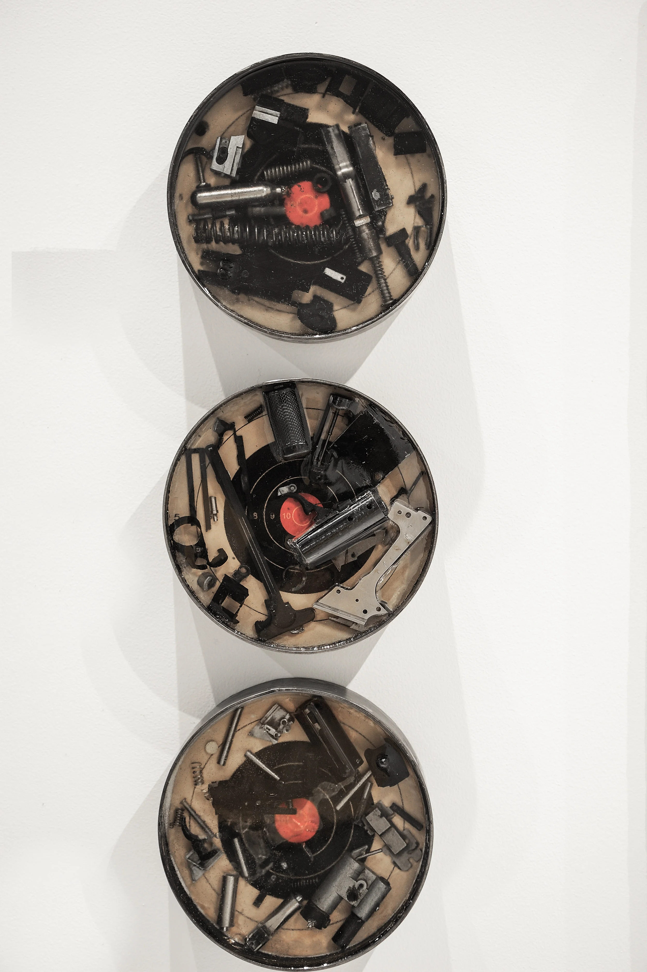 Artifact I, Artifact II, Artifact III 2019, steel, resin, gun parts, paper target, 9.125” x 9.125” x 2”