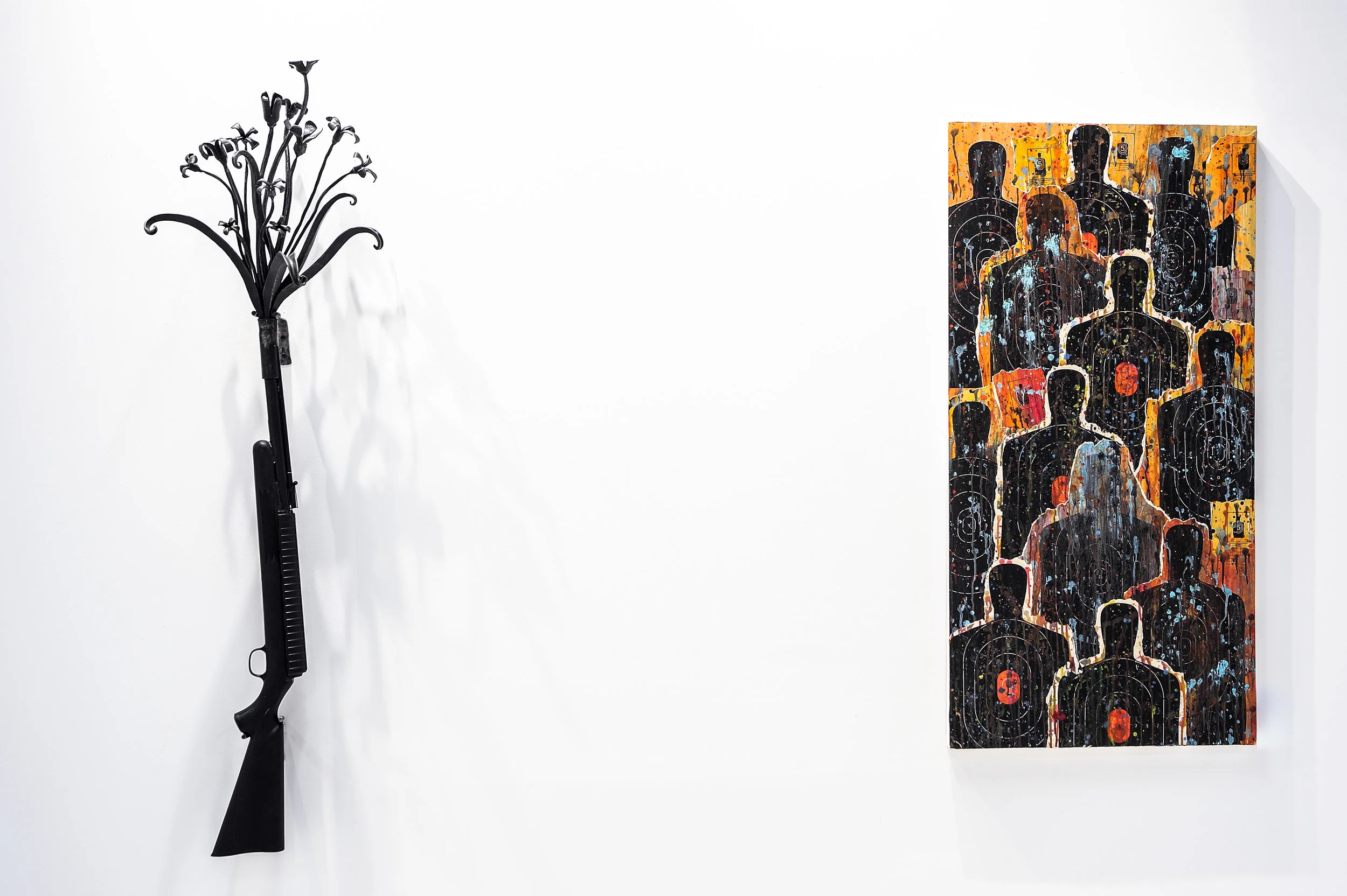 Rifle Bouquet , 2019, recycled guns and gun barrels forged steel, 57” x 15” x 10” In the Spirit Realm , 2019, acrylic, pigment, paper targets on panel, 4’ x 2’ x 1.75”