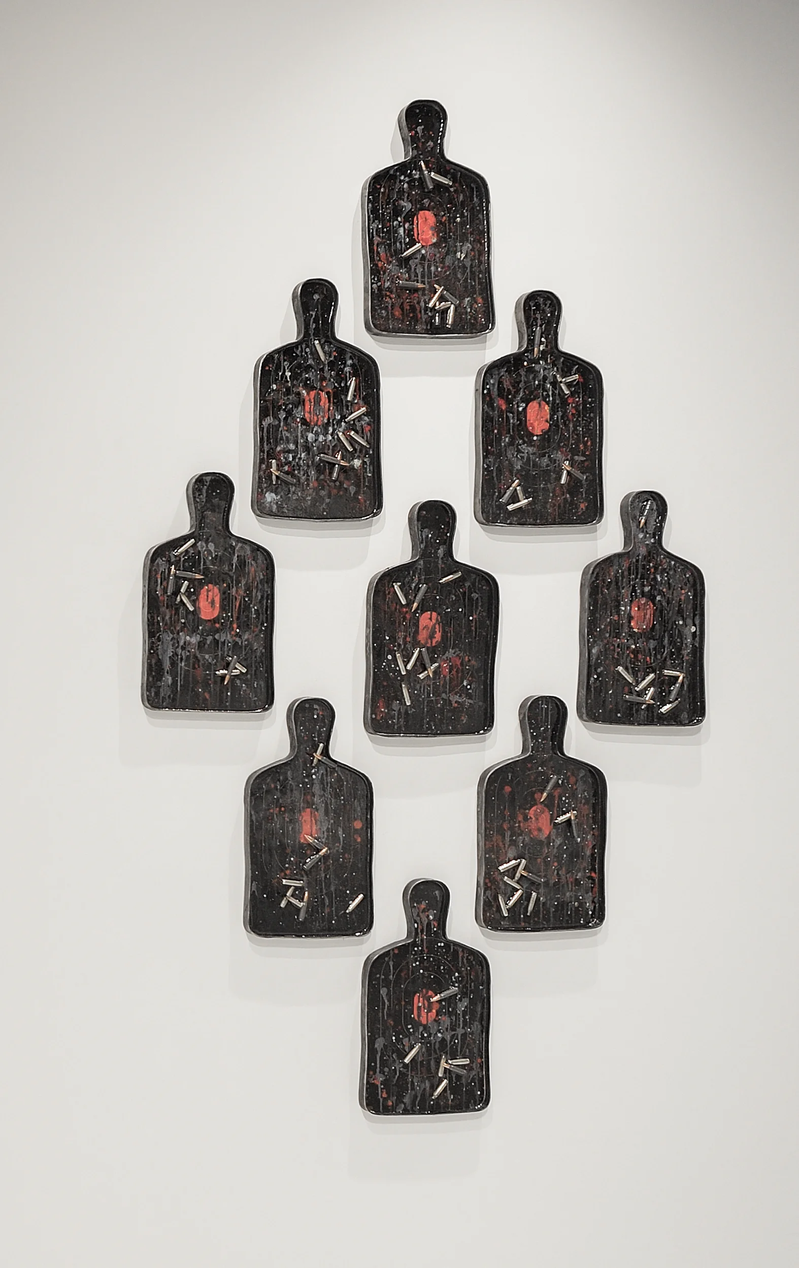 Fallen , 2019, acrylic, pigments, resin, paper targets, bullets (223 rem) and casings, forged steel, 17.75” x 9.75” x 1” (each)