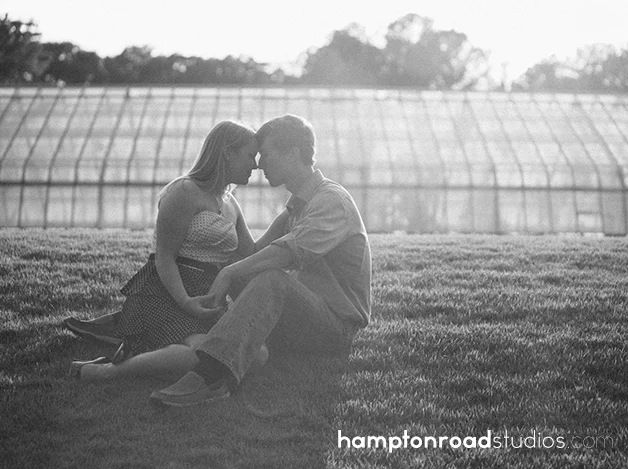 engagment on grass in front of greenhouse