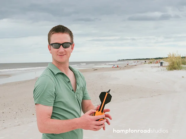 matt holding football on beach