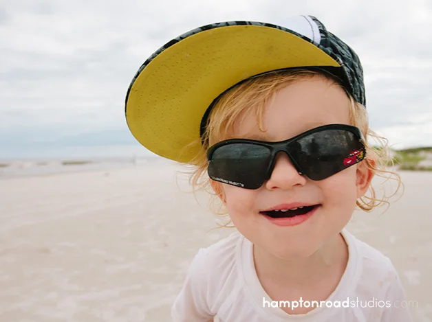 p smiling on the beach in batman hat