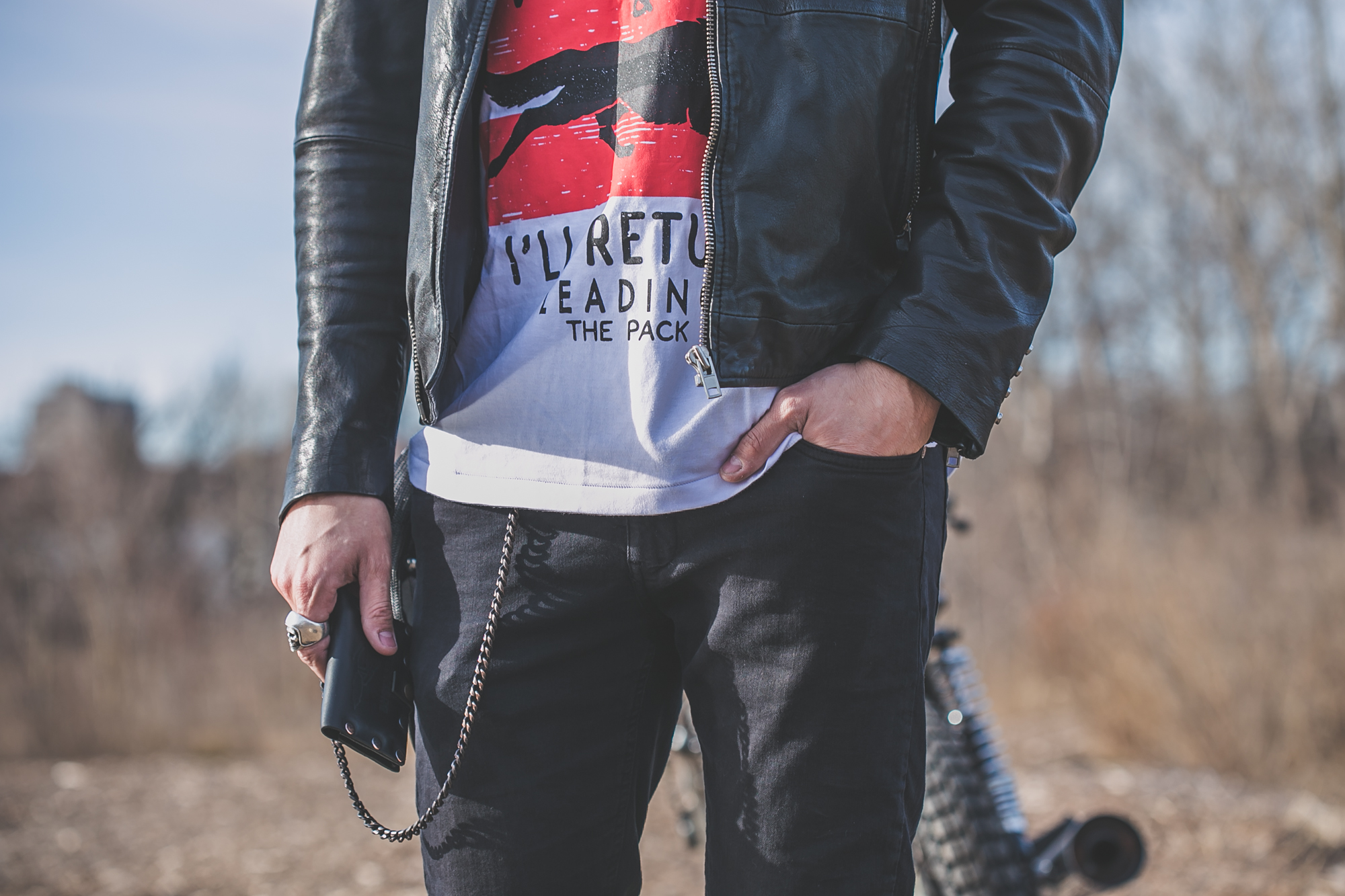 tattooed model in Anchored Apparel with motorcycle and Dusty Trade Co wallet