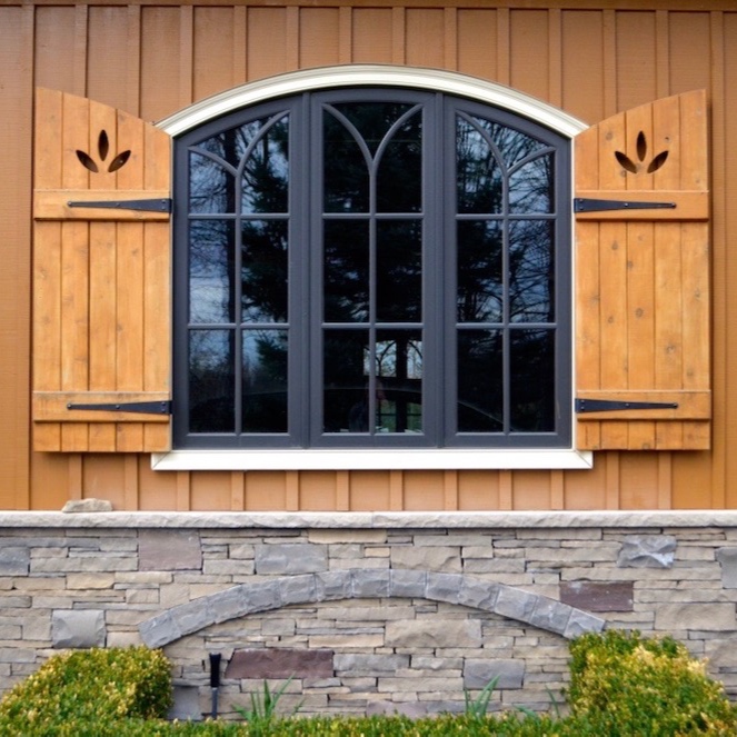 custom+home+board+and+batten+shutters+cedar+arched+top+window+stone+skirt.jpg