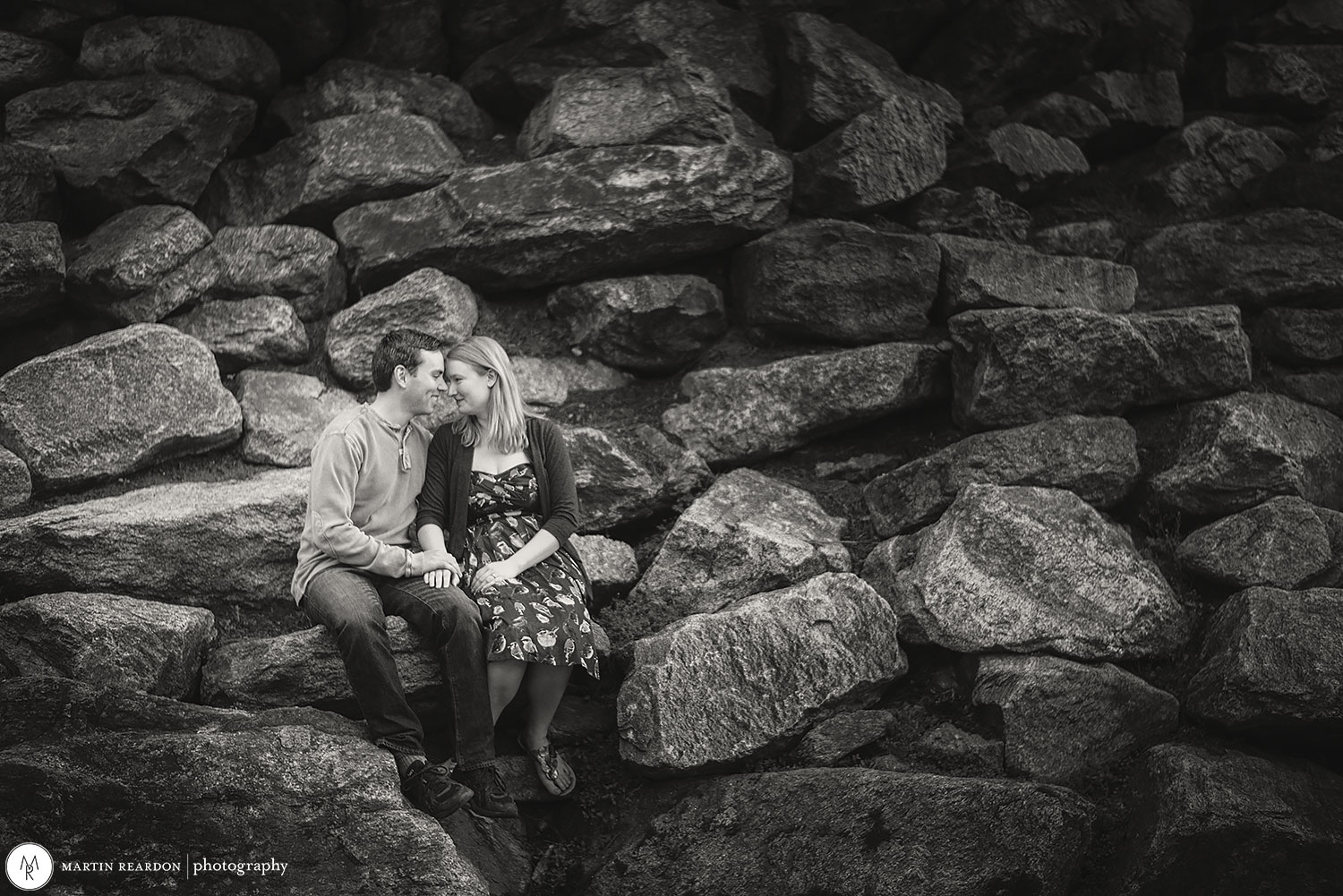 engagement photo couple sitting on rocks at Philadelphia Art Museum