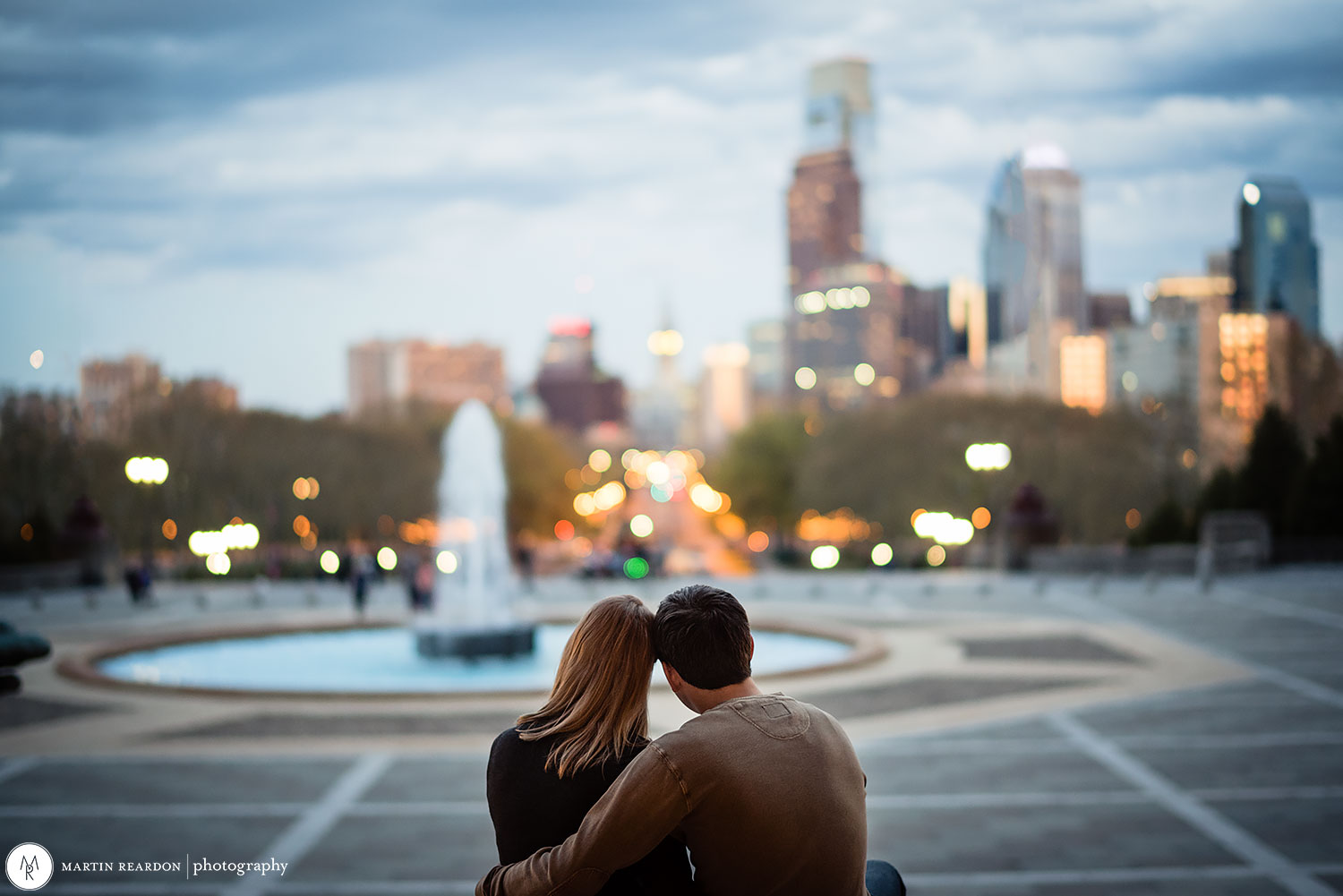 engagement photo couple looking at Philadelphia