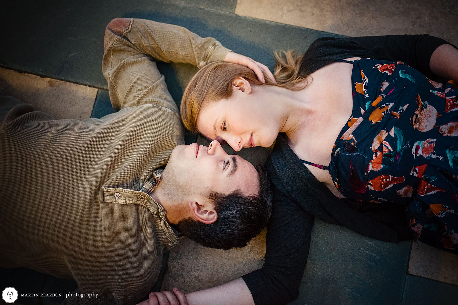 Engagement photo. couple laying on ground at Philadelphia Art Museum