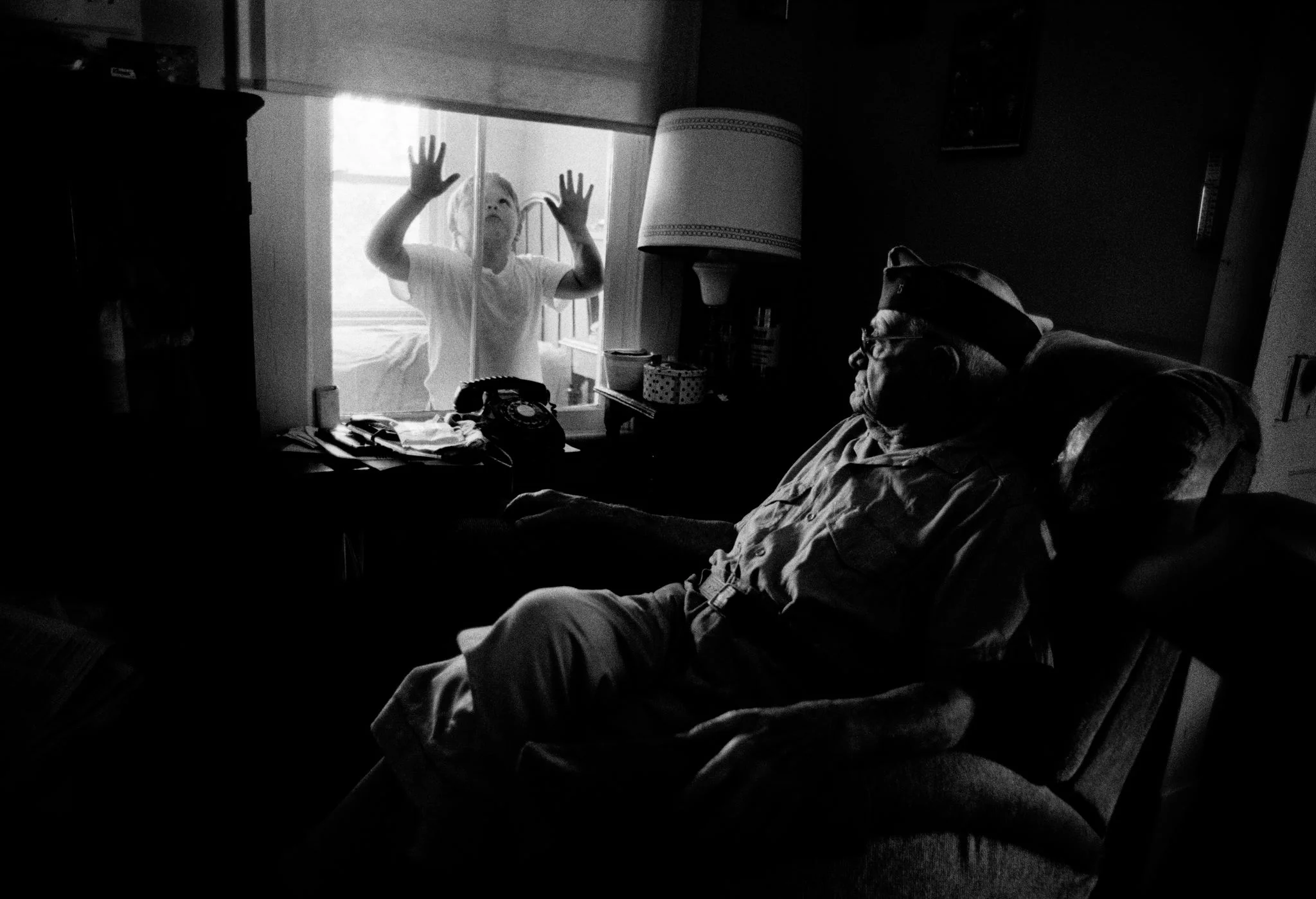 This photograph floated into my mind as I thought about what I could possibly say to you, a group of wannabe young journalists, sitting in a room, earnest, open, expectant. I tend to think in pictures, which float in and out of my head. And when I’m lucky enough or open enough or in the shower or whatever it is that predisposes the mind to latch onto and capture our most important and often elusive currency, which is to say our ideas, I try and stay alert to that. So this picture came into my head. I shot it years ago, when I was just beginning my career, when I was you. And I thought that World War I veteran sitting there, that’s me: ancient, a little broken, just sort of holding it together -- at first glance, at least. And that’s you, over there, that great-grandchild, face up against the window, clamoring to get in. My mother got cancer when I was 29. I was working at the Virginian-Pilot then, and took a leave of absence to take care of her. A few weeks turned into a few months and that eventually became six precious months together until she died, finally, from cancer and exhaustion and more morphine than oughta be legal. When it was clear early on she was terminally ill and needed me with her, the Virginian-Pilot encouraged me to go and do what I had to do and don’t even think about them and Godspeed. And they stayed true to that. They also kept me on the payroll the entire time. The entire time. That, my friends, was the gilded age of journalism. I bring up my mother because when I think of the waves of grief I have endured in recent years, having experienced this slow motion collapse of the world of big and of institutions and of journalism as we understood it, and just, gosh, the entire revolution that is happening, and the redefinition of the craft and how we practice it; When I think of all the amazing minds that have left the industry -- whether through layoffs or just because they couldn’t stomach it and they’ve got kids to take care of and all the real and legitimate reasons, and even some of the phantom reasons, and just the cumulative effect of all of it, of these tremendous, tsunami-size waves of grief; Well, it’s not like losing your mother. But it’s close. If you don’t have the mettle for the atmosphere I am describing here you should walk away now and don’t look back -- while you still have plenty of chance. But if, like me, you can’t imagine a life without all the interestingness, the access and the steady stream of fascinating people and stories and of the beauty that is our everyday ordinary, our privileged experience, then by all means, welcome. Who am I to get in your way. Throw everything you have at it. Be nimble. Be open. And play those two words on repeat. Nimble, open, nimble, open. Which brings me back to this picture. Because the best work in whatever form contains nuance and metaphor and often a little irony or paradox, and because wherever there is shadow there will always be light, I thought well, sure, that’s me, that old guy. That much is obvious. But I’m also that little kid, alive with the possibility and power of journalism, hands pressed against this window of opportunity I have with the work, and with you here now. In ancient myth, as in life, wherever there is death, there is often rebirth. And I think that’s where we are now. I’m often pretty much baseline emotionally exhausted these days. But also – and please hold onto this if nothing else – I’m exhilarated.