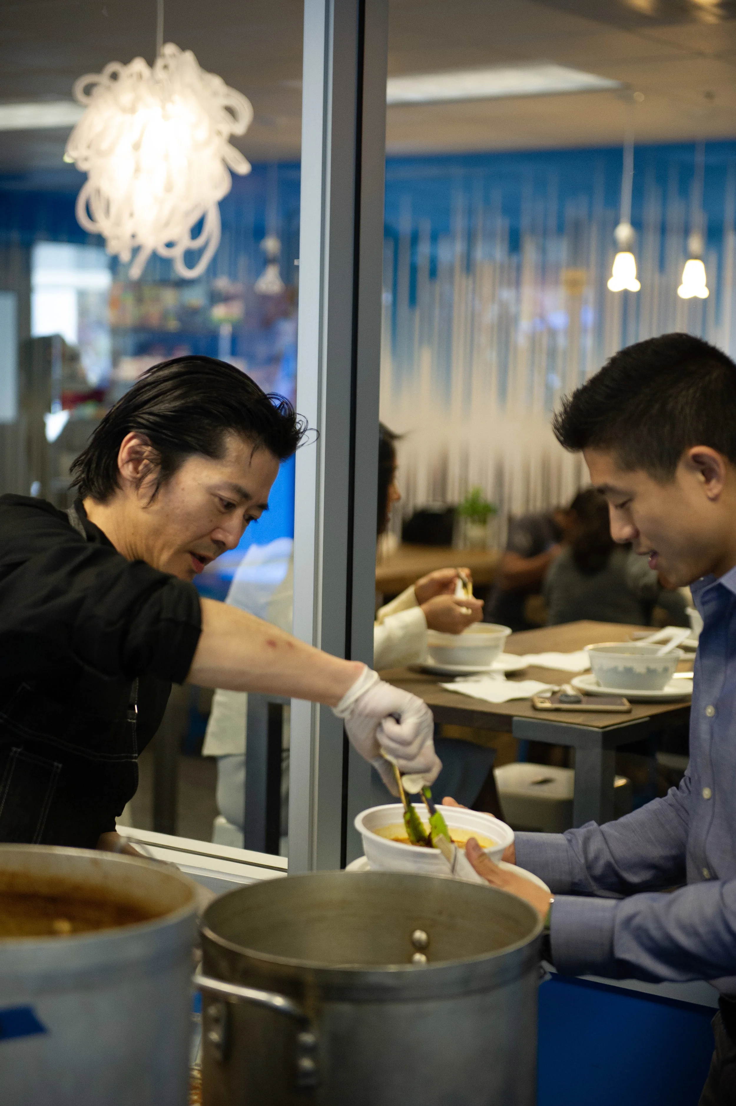 Chef Kenichi puts the finishing touches on a spicy Kimchee Ramen bowl.
