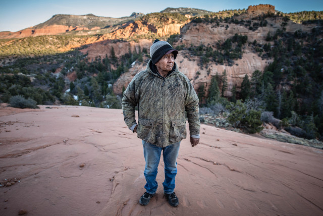 James Smith, 70, surveys five former Kerr-McGee uranium mine sites near his home in Cove, Ariz., where Smith, his three brothers, and hundreds of other Navajos tunneled into the rugged Lukachukai Mountains. Radioactive material hauled from the mines remains piled in populated areas of Cove while officials decide how to dispose of abandoned mine waste. (Roberto E. Rosales/Albuquerque Journal)