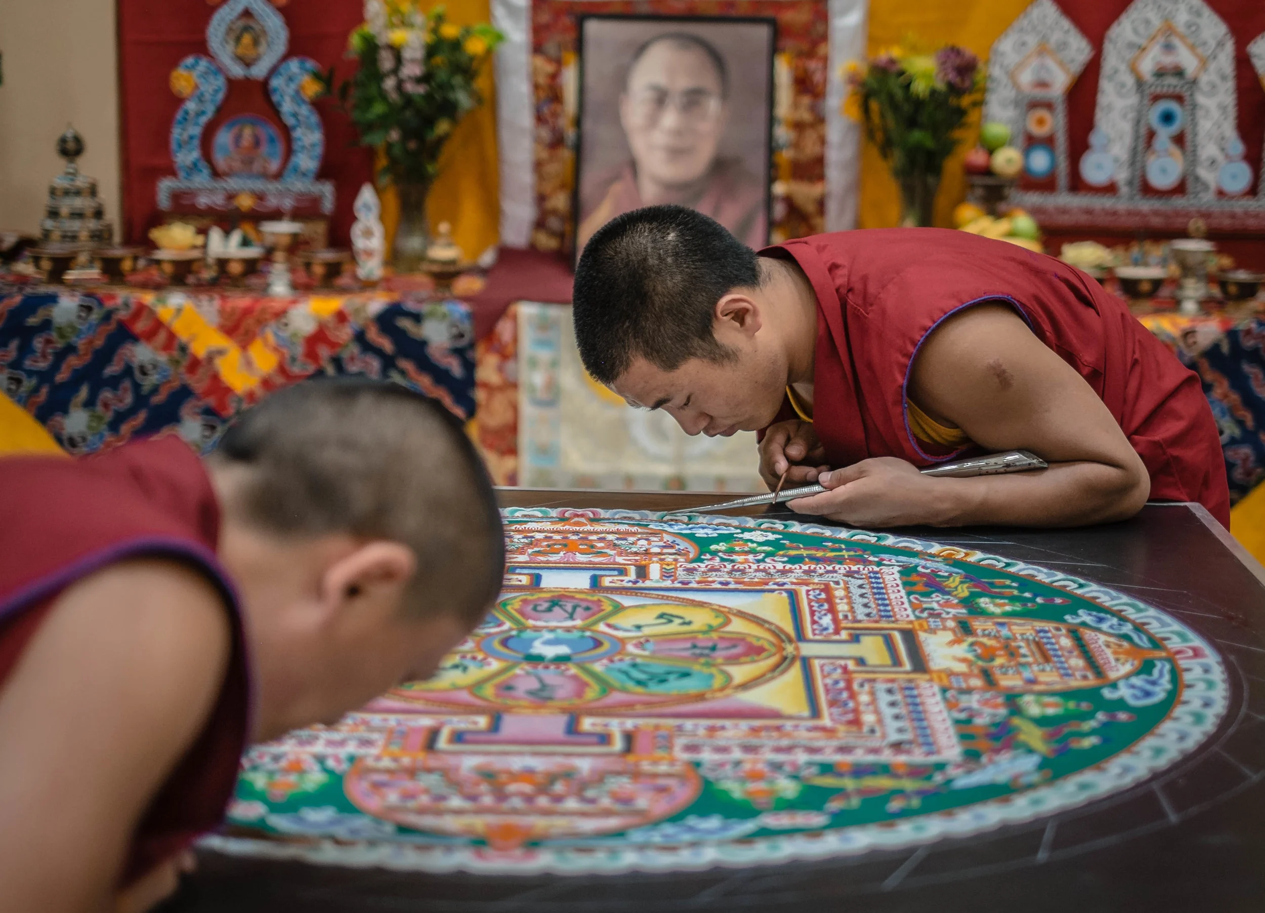 Tibetan monks continue work on a Mandela before performing at the University of New Meixco
