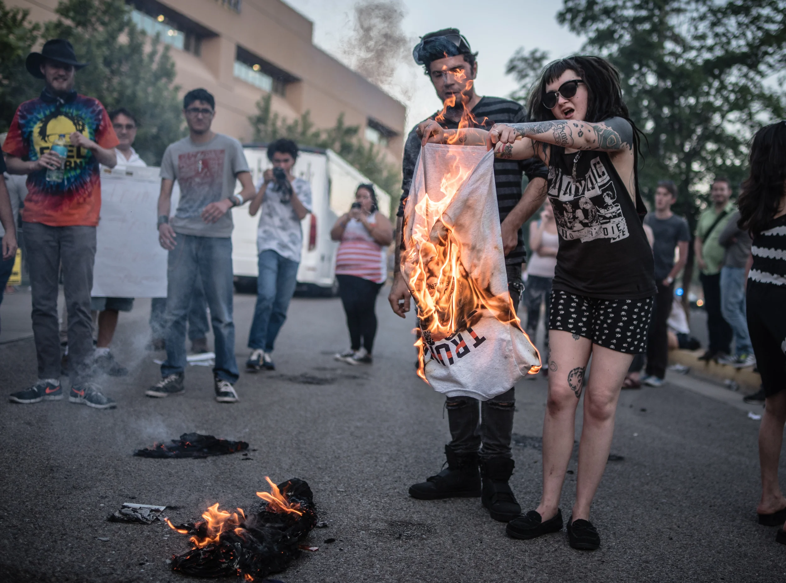 A protester burns a Donald Trump shirt during a demonstration