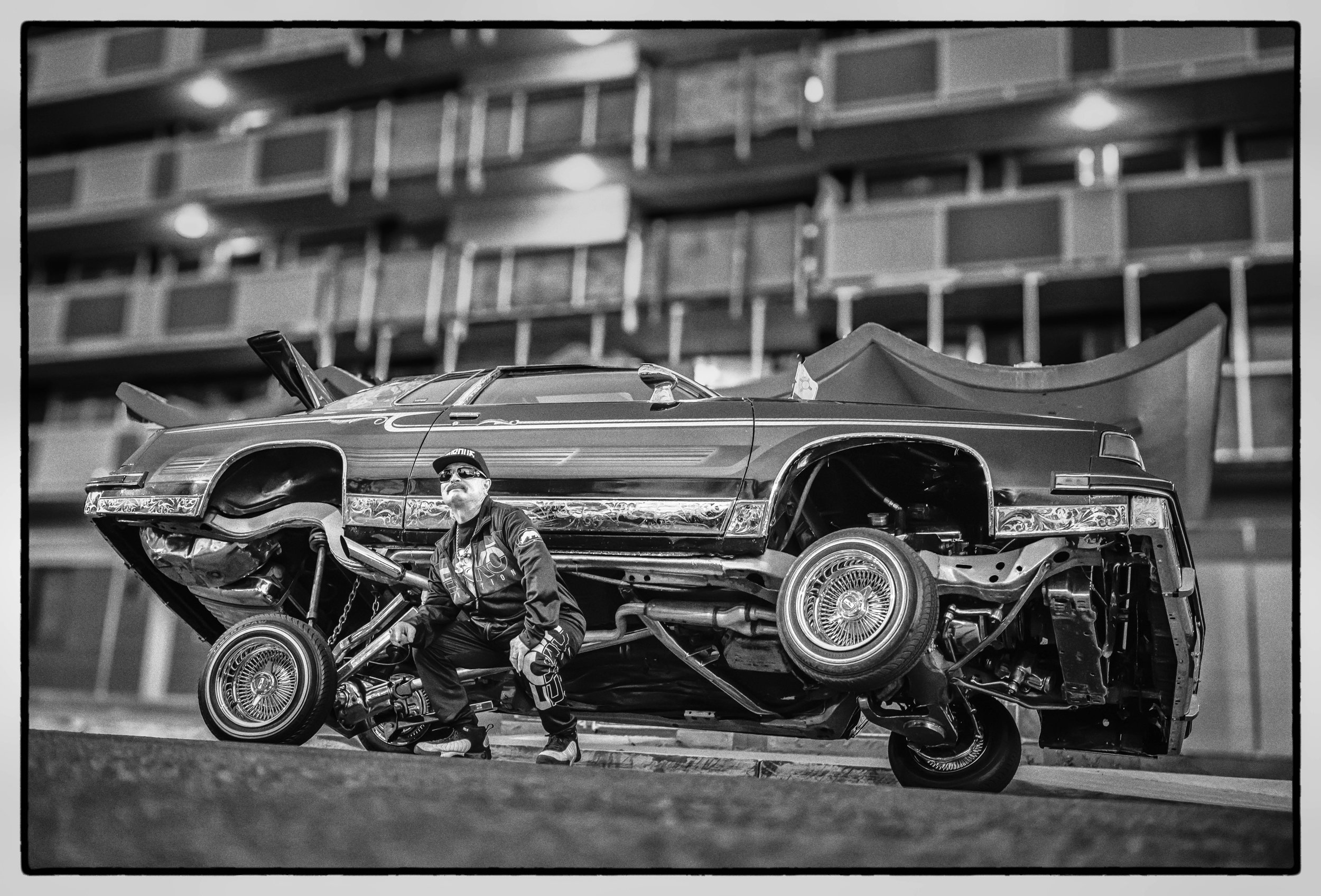 Filimon Pino and his 1987 Oldsmobile in downtown Albuquerque