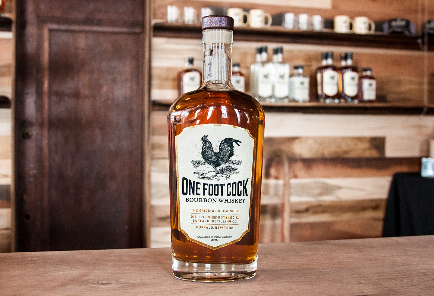 One Foot Cock Bourbon - Born on the 4th of July One Foot Cock Bourbon Whiskey has been a hit since our first two barrels were released on the 4th of July 2014. This is the first Whiskey from the Buffalo Distilling Company in 100 years and the the first Bourbon Whiskey in WNY ever. Local corn, wheat & barley make up our mash bill for a flavor that is unique, resplendent and a true snapshot of Buffalo's flavor profie. This is our flagship whiskey and destined to be the "paw-paw" in our legacy. Life is a game of inches - make it a One Foot Cock .