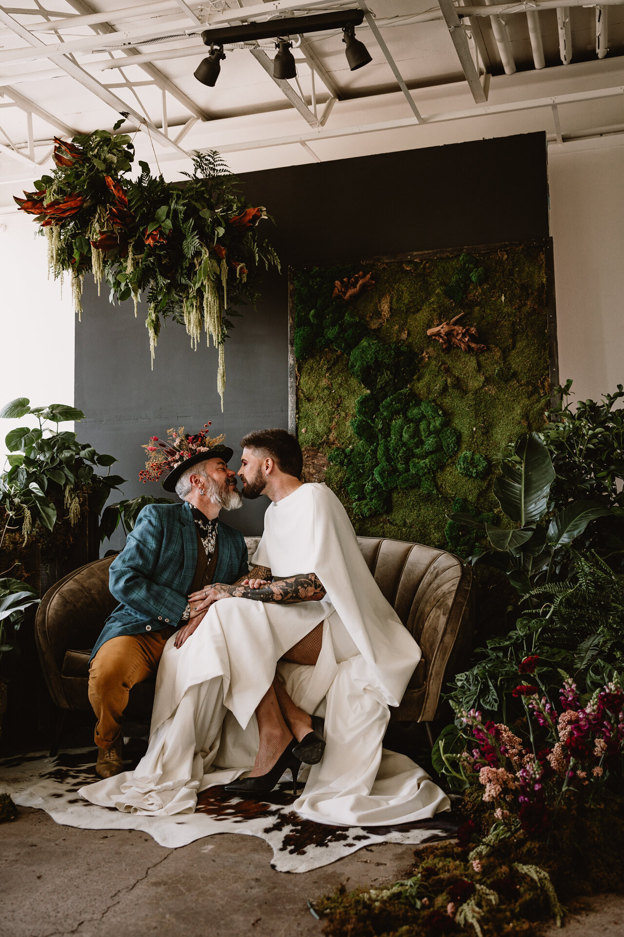  Lush + Leather intimate LGBTQIA+ styled shoot at Denver Photo Collective in the gorgeous Vagabond Zoe wedding gown and Eos cape photographed by Storih Photography 