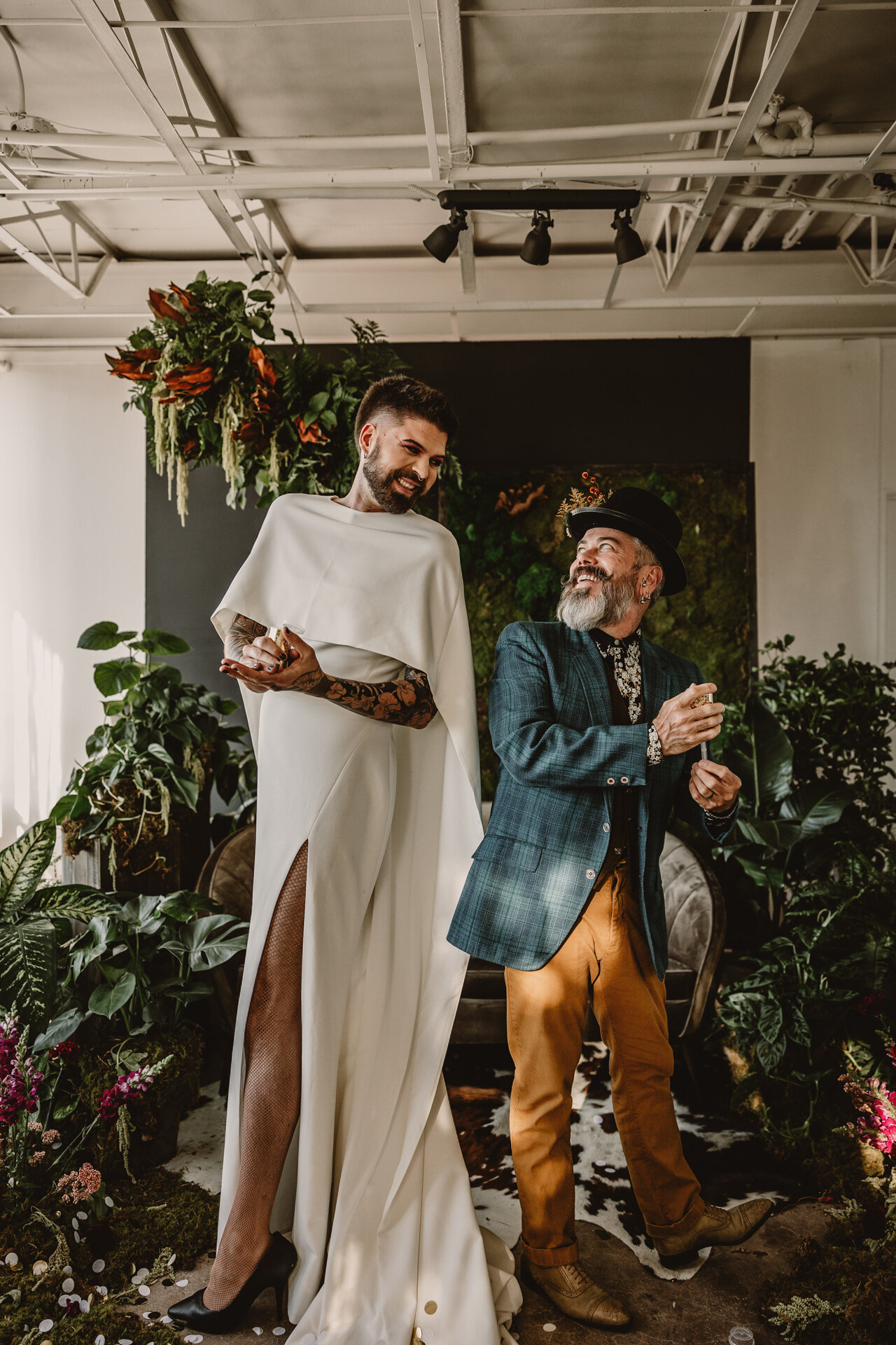  Lush + Leather intimate LGBTQIA+ styled shoot at Denver Photo Collective in the gorgeous Vagabond Zoe wedding gown and Eos cape photographed by Storih Photography 