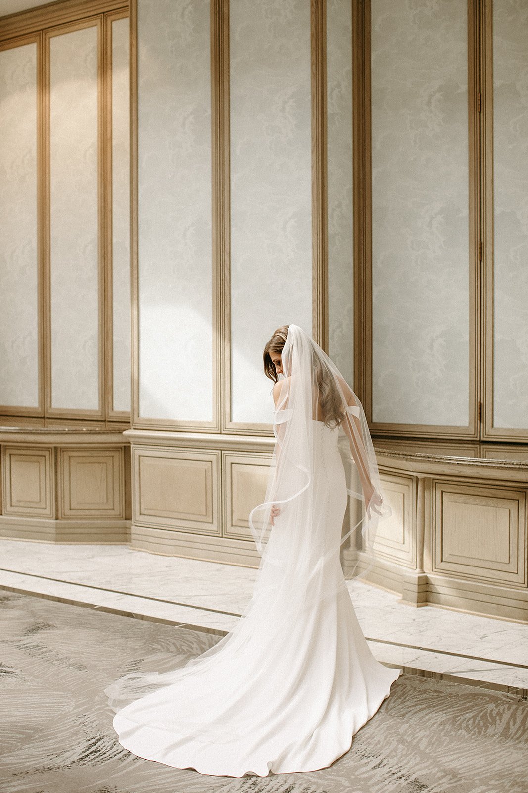  A bride wearing the Julianne Veil by Sara Gabriel and the Camila wedding dress by Alyssa Kristin in the lobby of the Four Seasons Hotel in Dallas, Texas 