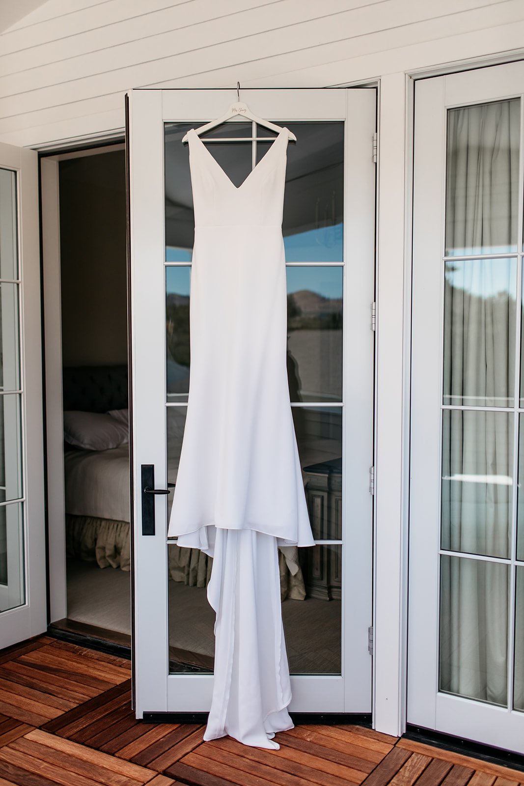  Alyssa Kristin Maven wedding dress hanging in the bridal suite ready to be put on. 