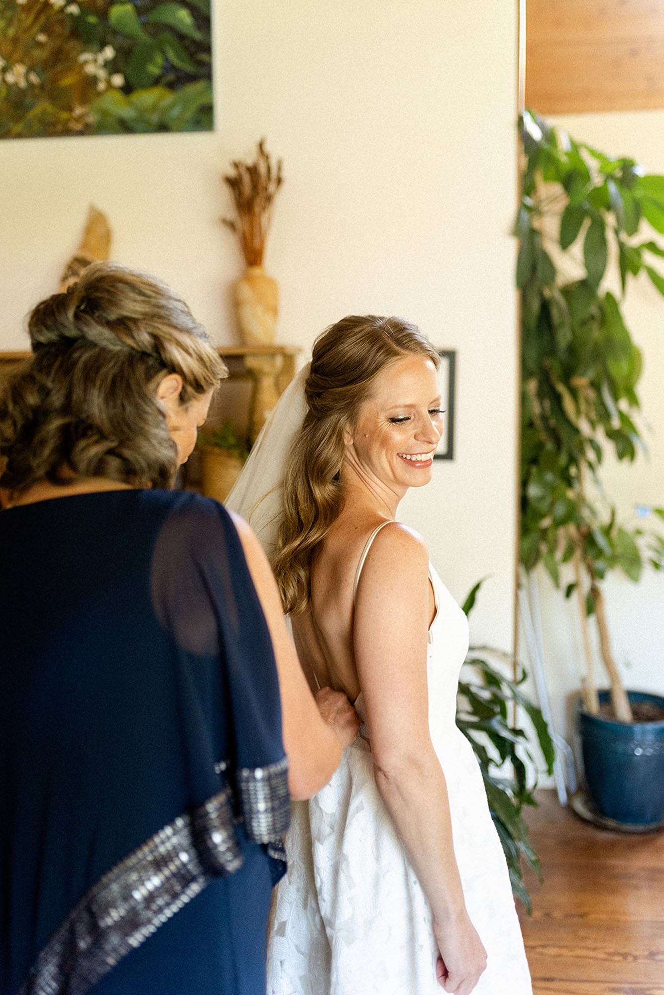  The mother of the bride zipping the bride into the Annie wedding dress by Truvelle bridal 