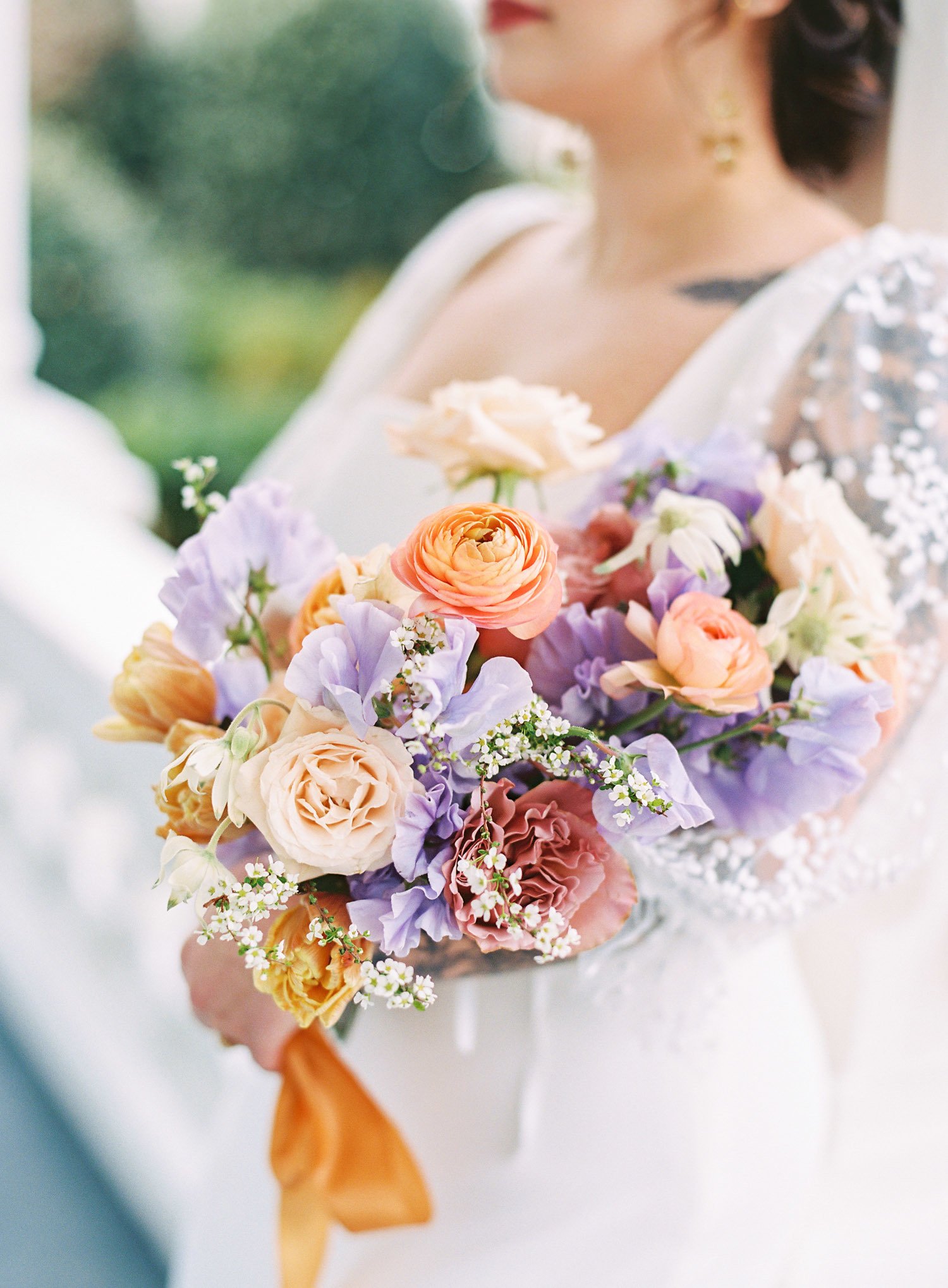  a romantic bridal bouquet of orange, purple, cream, peach, and white with a lovely orange silk ribbon 