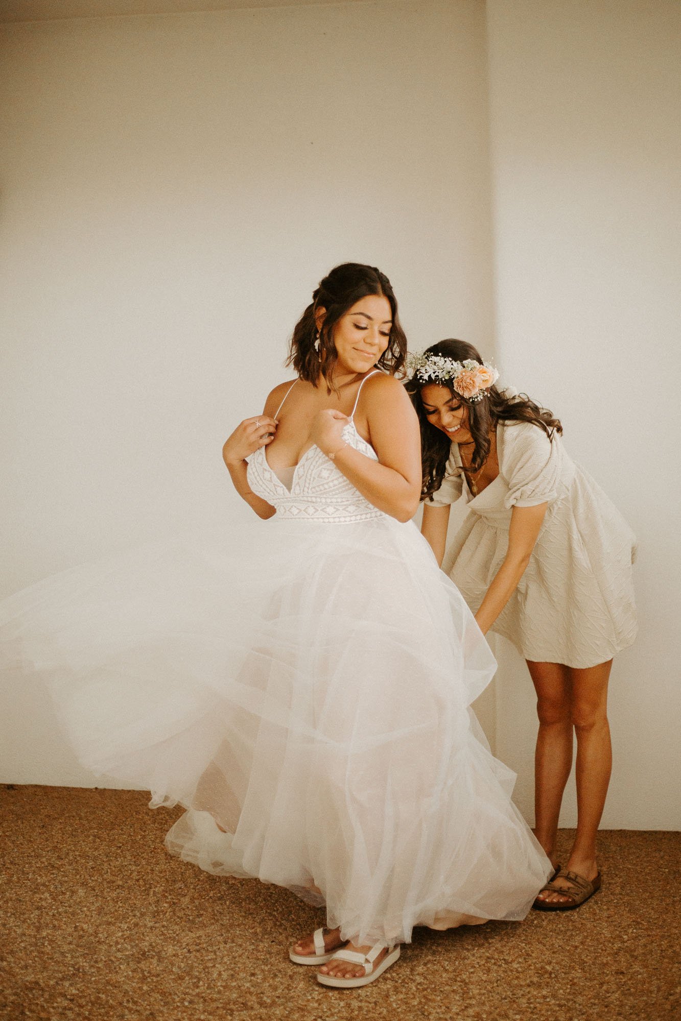 a romantic and boho bride wearing ‘thistle’ wedding dress by willowby by watters for a fun desert elopement in new mexico