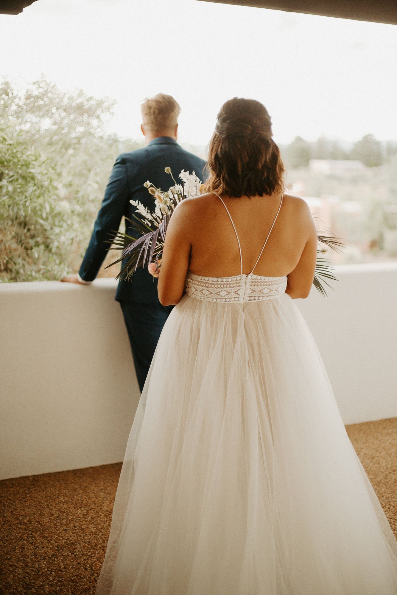  a bride wearing the willowby by watters thistle wedding dress walking towards the groom for their first look for their new mexico boho desert elopement 