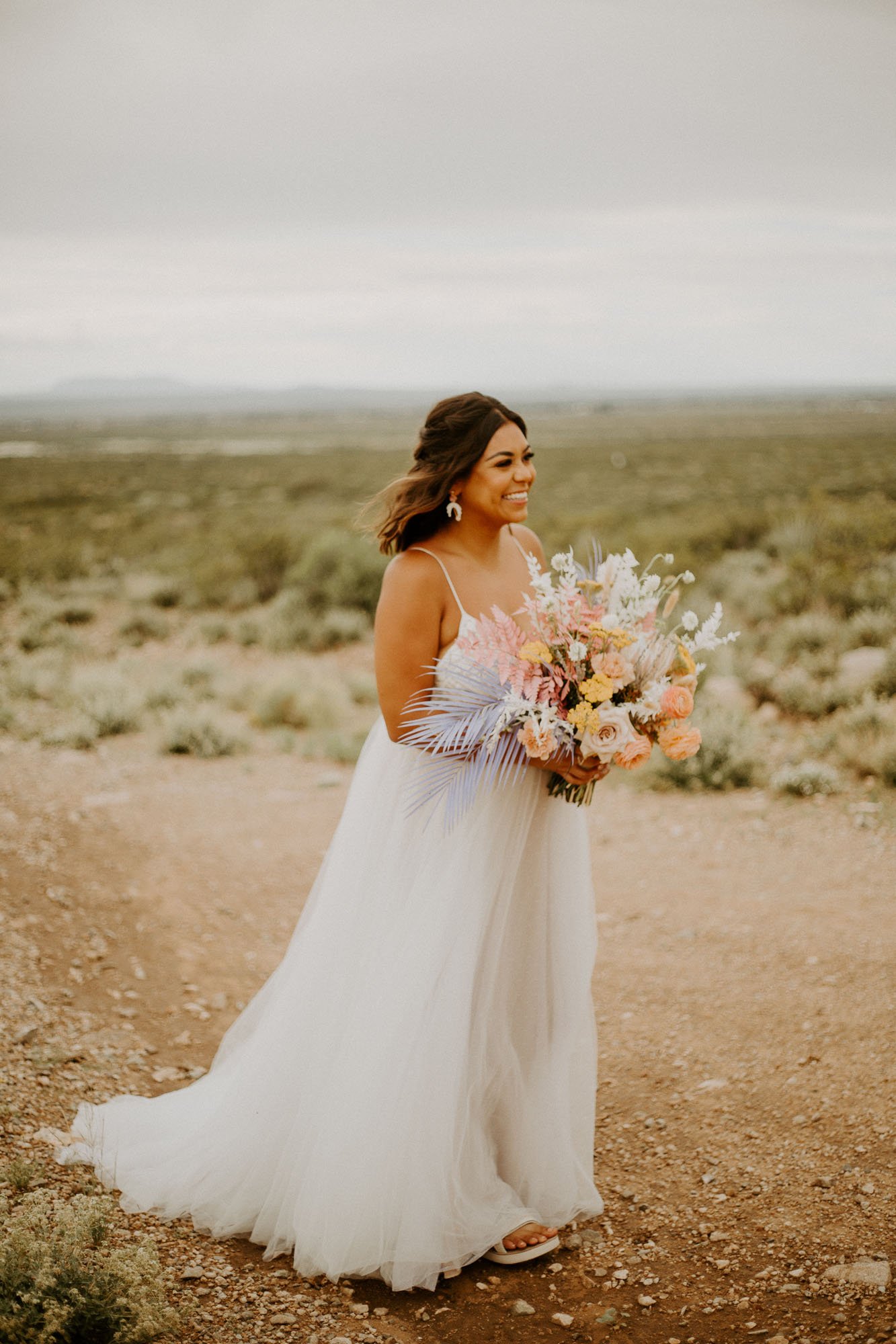  a bride in the desert in new mexico for an eccentric elopement wearing thistle wedding dress by willowby by watters 