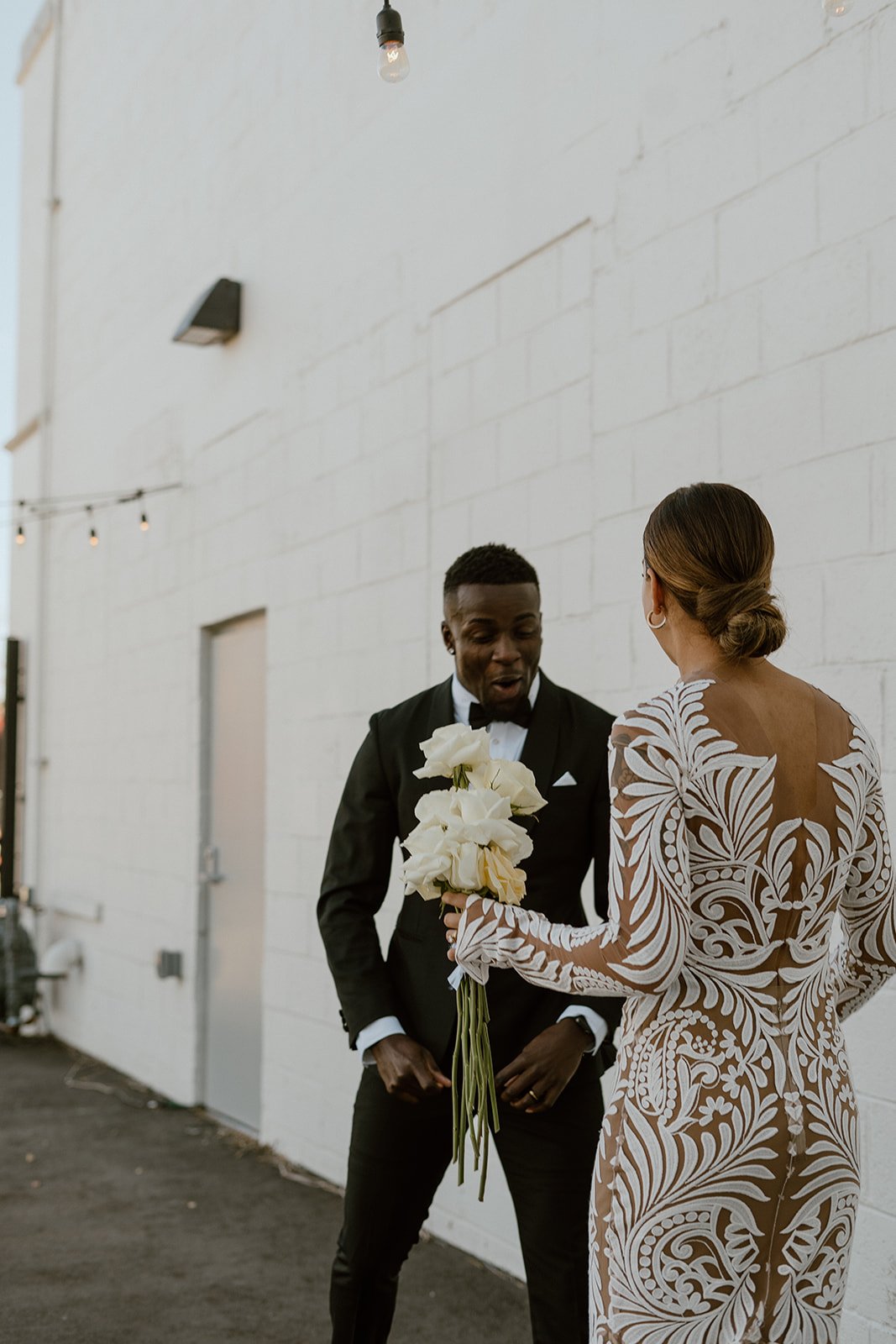  a groom awestruck seeing the bride for their first look for their industrial chic wedding in colorado 