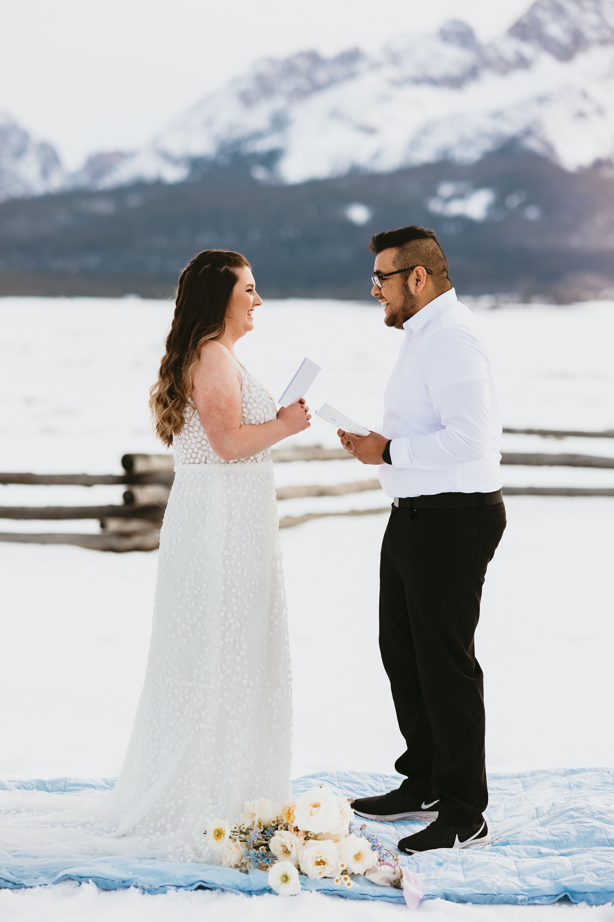  A bride and groom exchanging their vows for a remote mountain elopement in the snow near Boise, Idaho. 