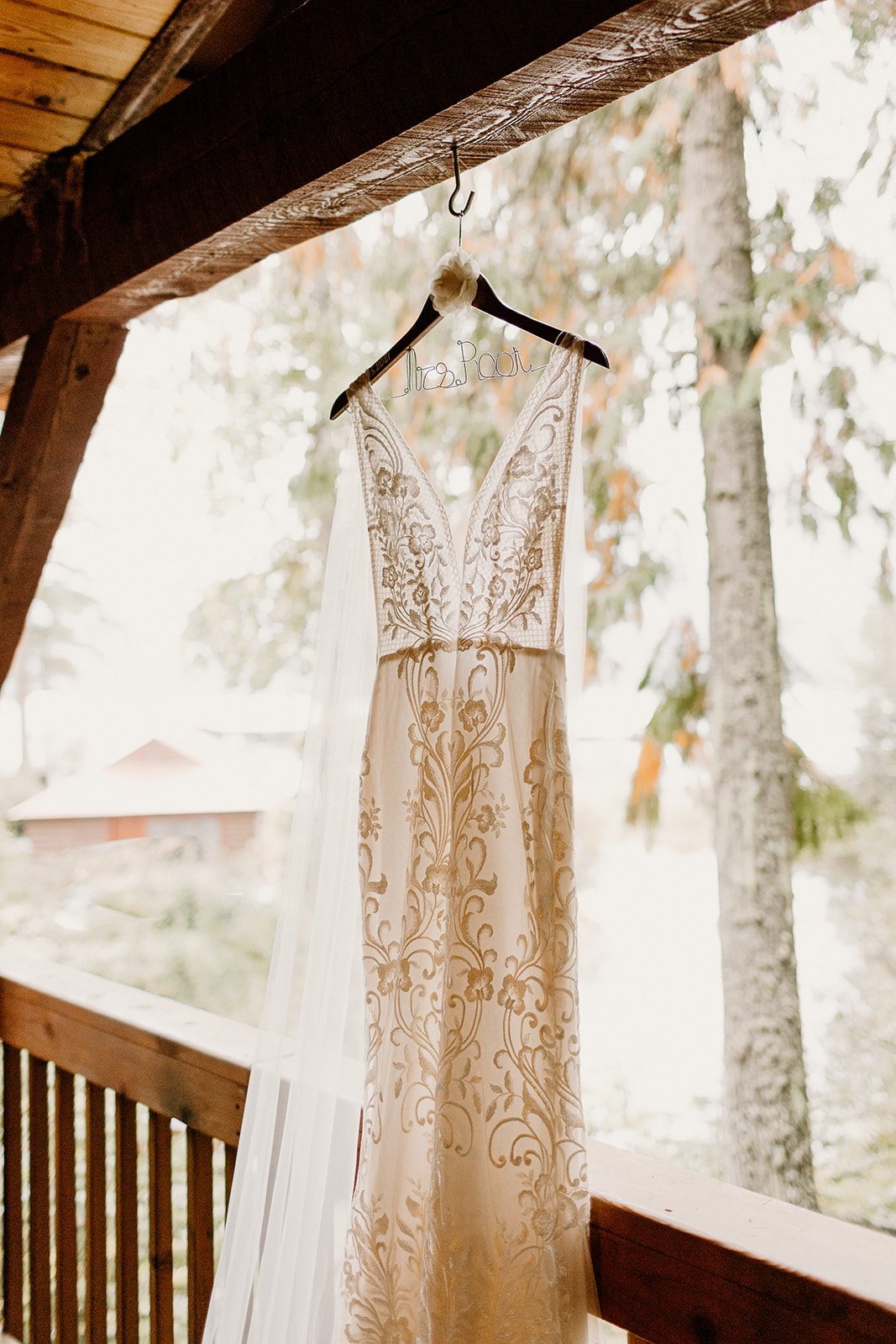 made with love riley luxe wedding dress hanging in cabin window