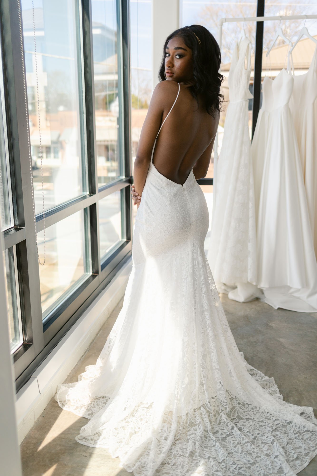platte by the label is a lace open back wedding dress by aandbe bridal shop
