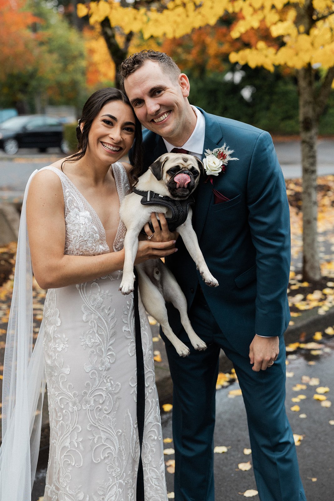 real wedding with a bride and groom holding their dog featuring riley by made with love bridal 