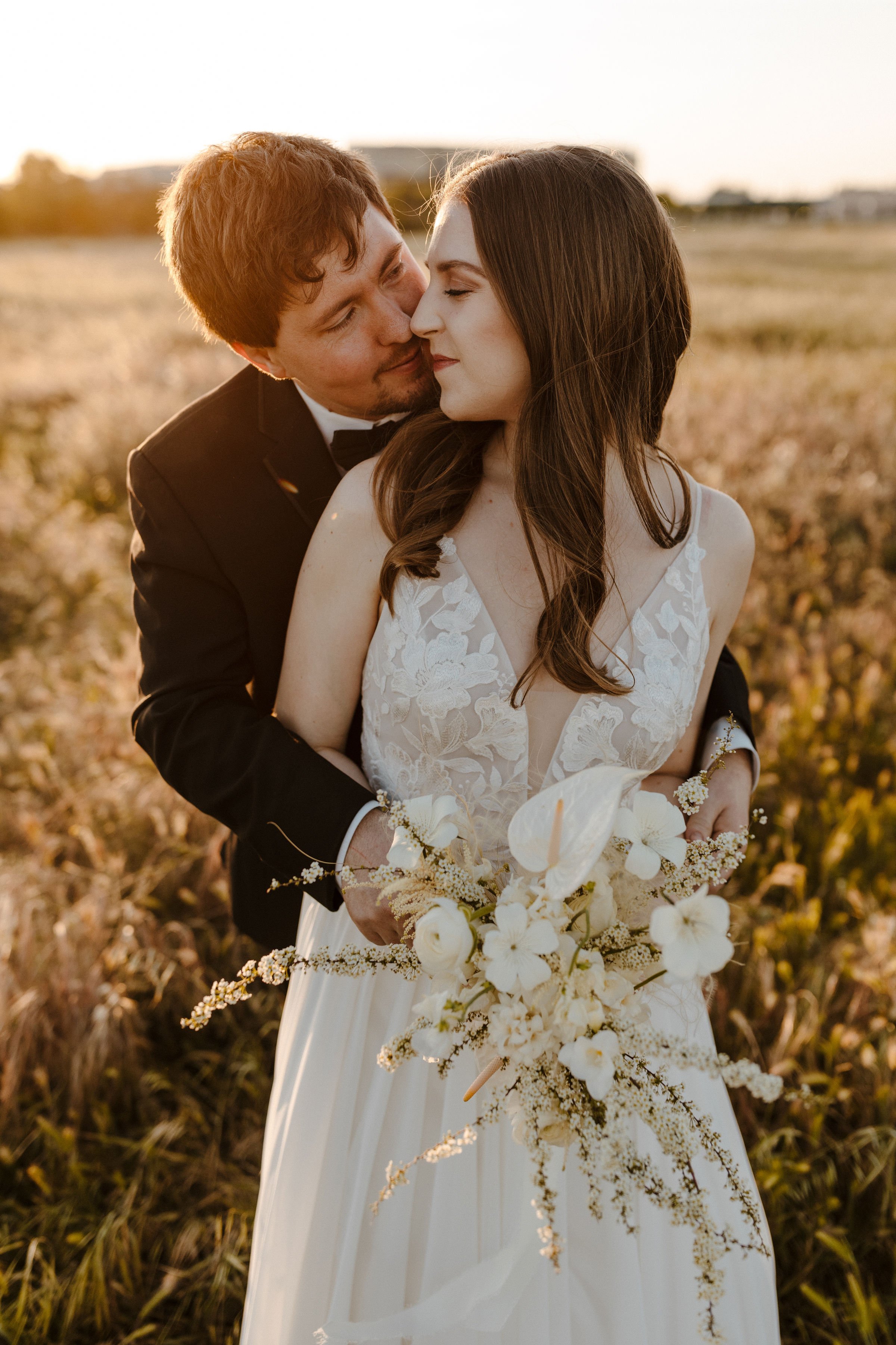 a real jenny by jenny yoo bride wearing cambria in a field during golden hour