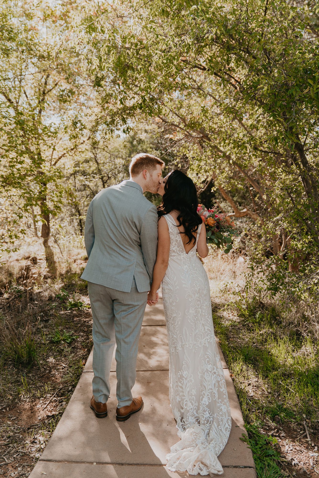 an outdoor ceremony in sedona arizona featuring riley luxe wedding dress by made with love