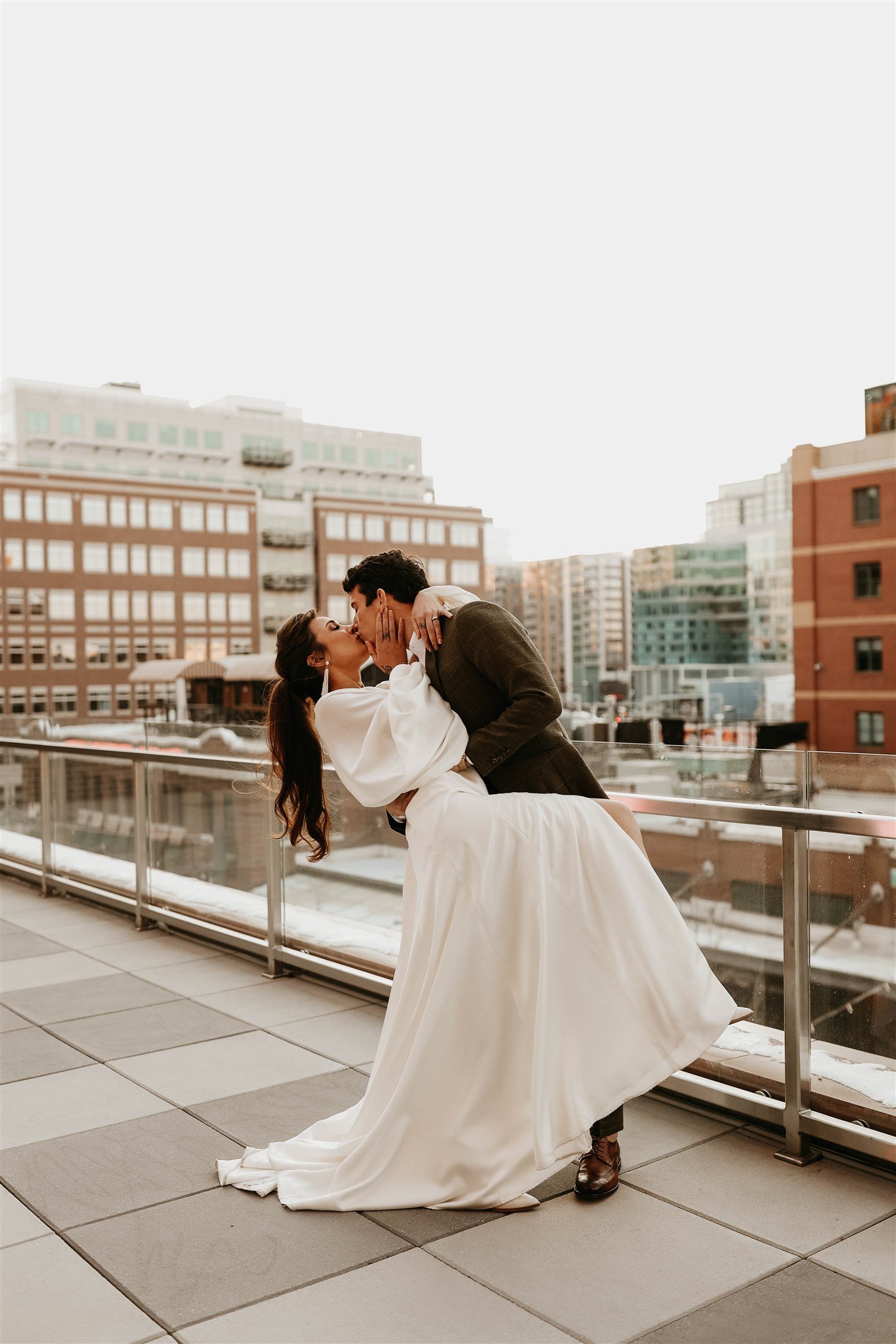 a styled wedding on the rooftop of the rally hotel in denver colorado in a longsleeve wedding dress by willowby.