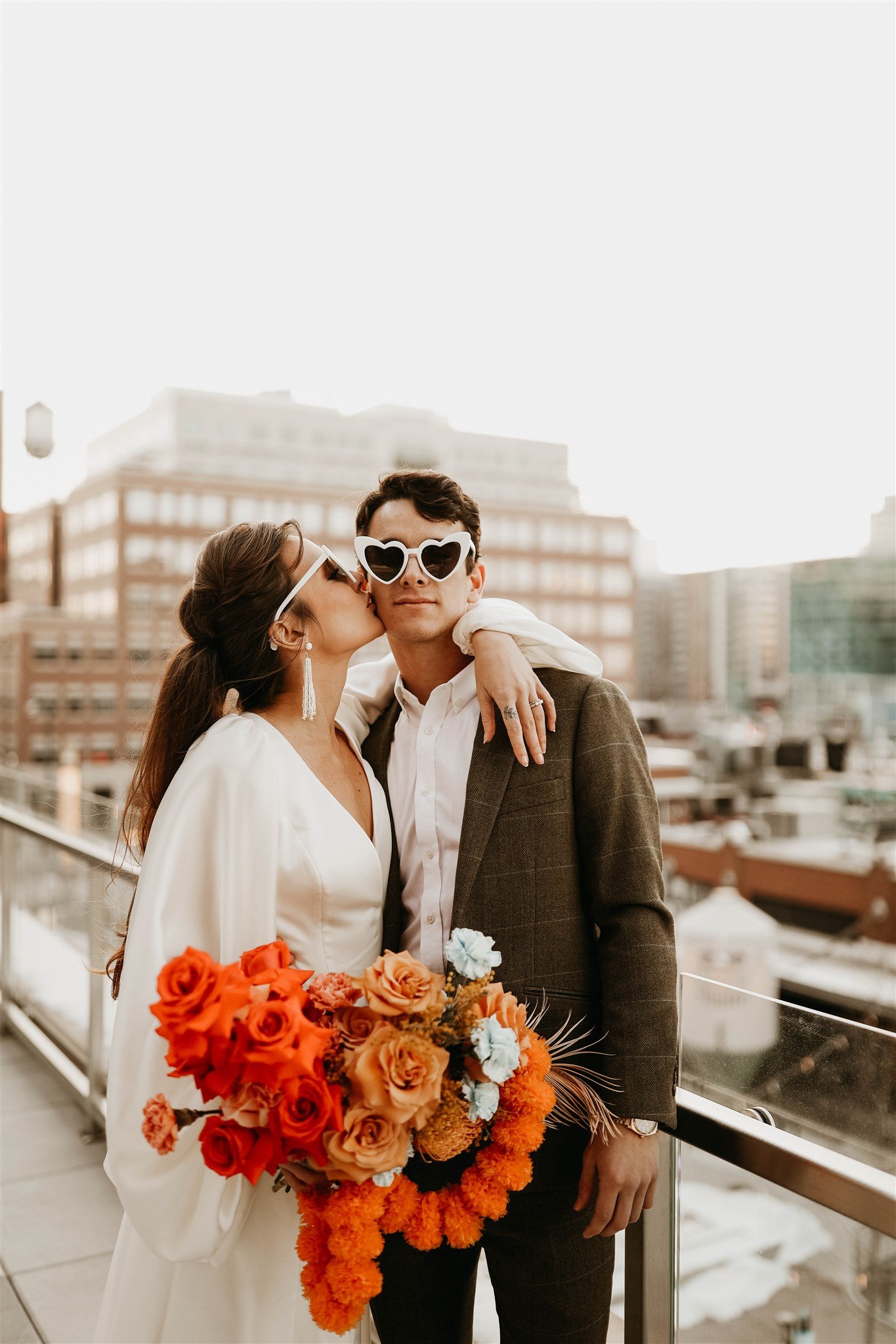a wedding on top of the rally hotel in denver colorado with a cool vintage vibe in a willowby long sleeve modern wedding dress.