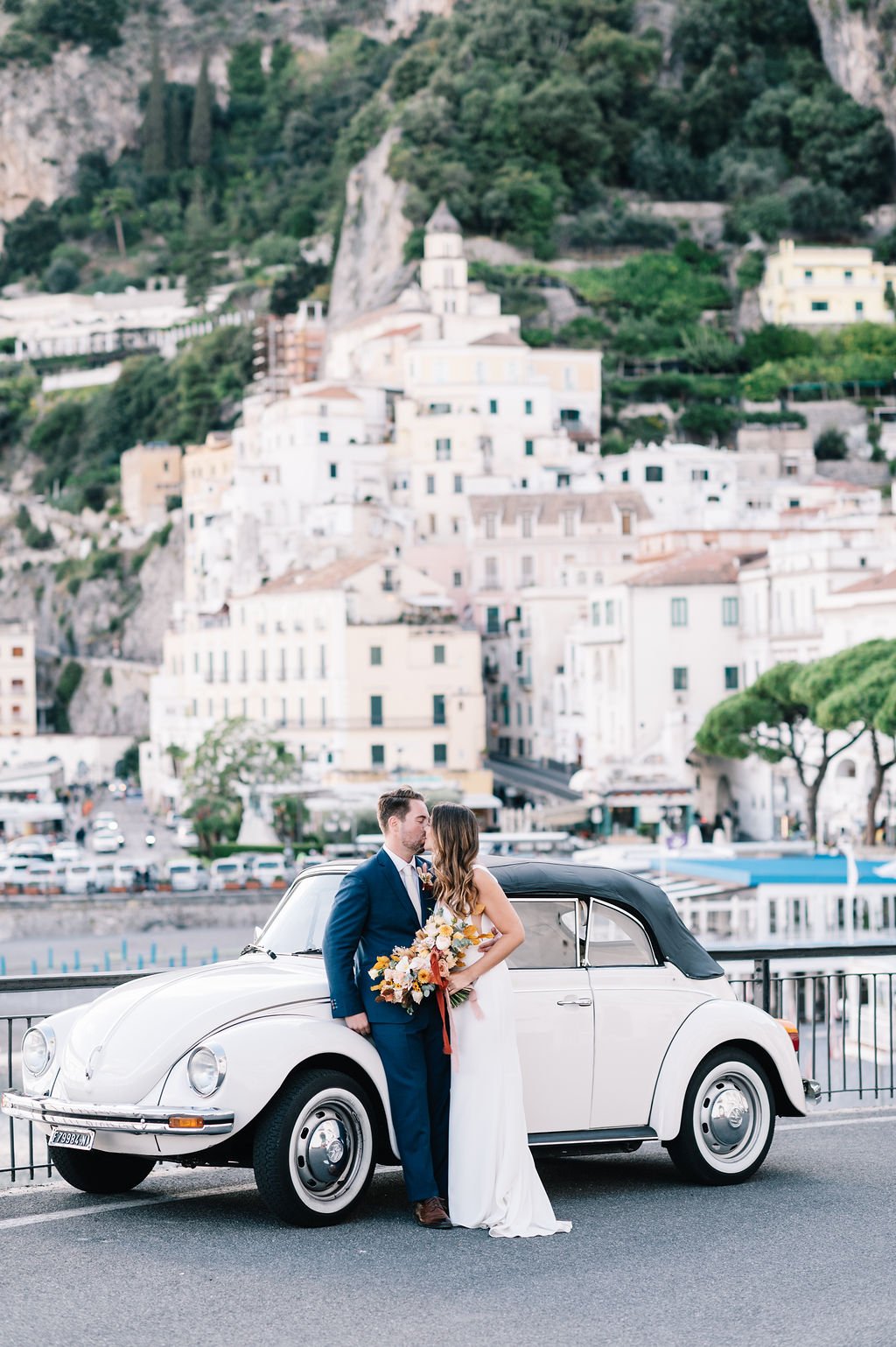 amalfi coast elopement featuring classic car and simple made with love wedding dress