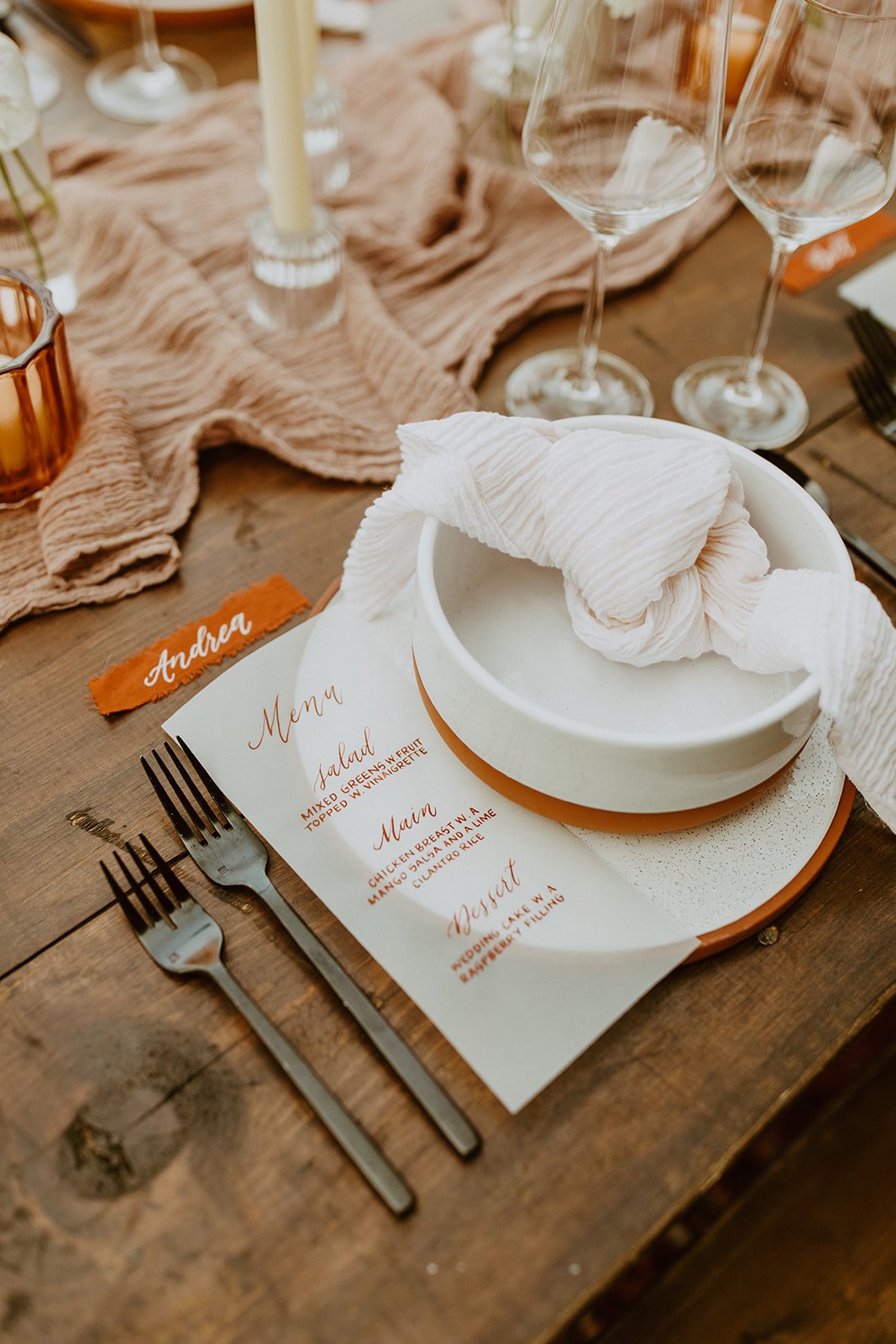 rustic boho wedding reception styled shoot with deep orange tones and wood accents.